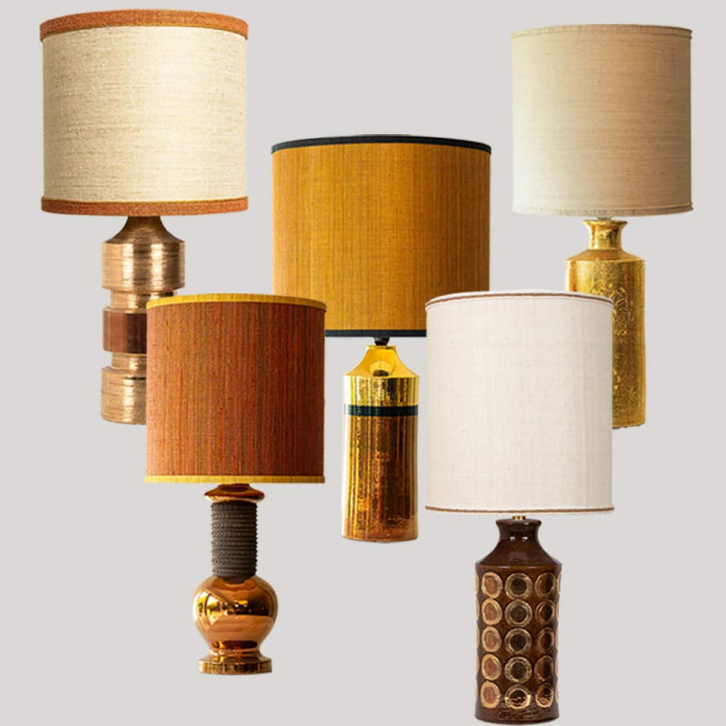 One of the five XL floor and table lamps, 1970s.

This set brings a rich visual appeal to any interior. With its beautiful shapes, it offers a unique presence. 

The gold and warm colored bases and beautiful shapes fit perfectly with the custom made