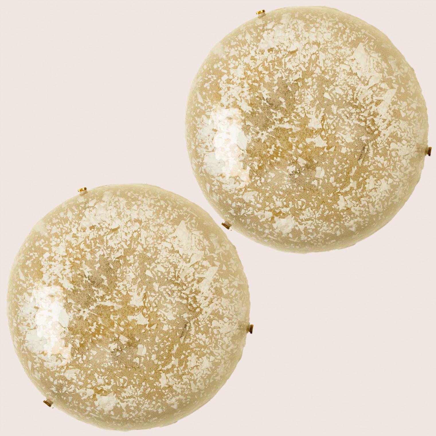 Modern thick textured brass glass flush mount , Germany circa 1970. The flush mount is featuring a huge round handmade glass disc. The glass has a texture like snowflakes in it.

Can also work for impressive wall lights. Clean and simple design with