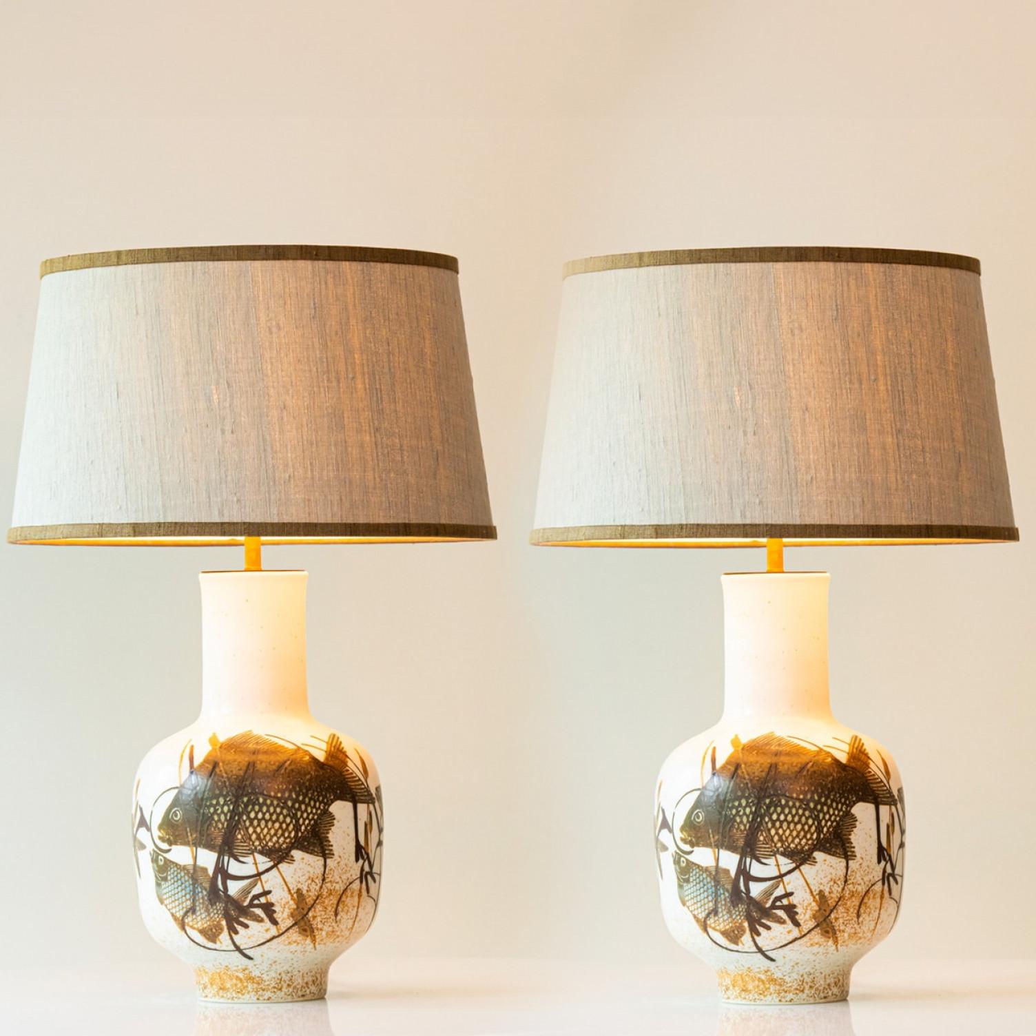 One of the two heavy quality ceramic table lamps.

This lamp base brings refined elegance and rich visual appeal to any interior. With its beautiful shape, it offers a unique presence.

This beige base with a fish motif on it fits perfectly with the