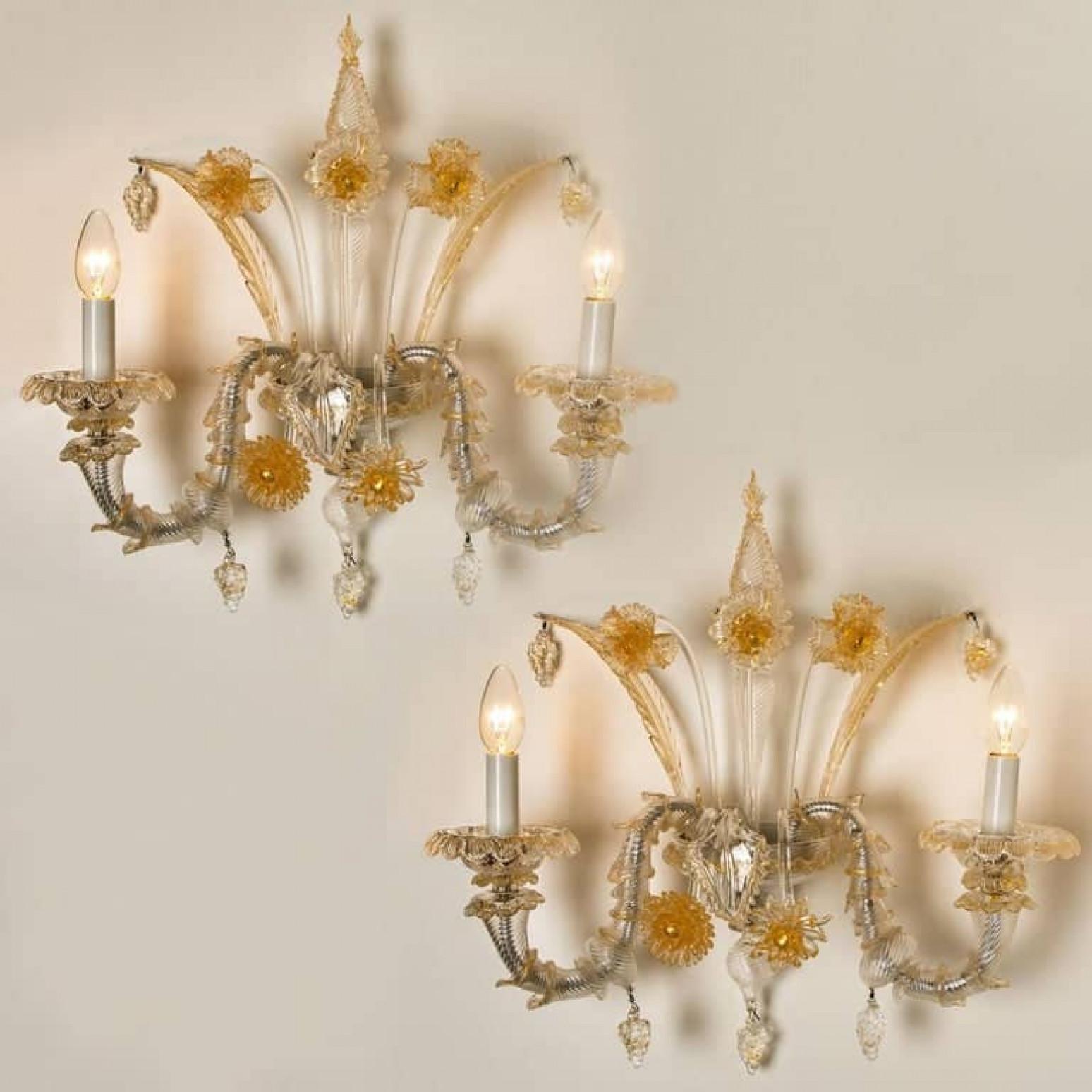 A truly rare and outstanding pair of wall lights, the lights are handmade in ribbed and curled colorless glass with aventurine inclusions. Statement pieces. Beautiful craftsmanship, Venice, Murano, circa 1960.

With grey metal mounting, central