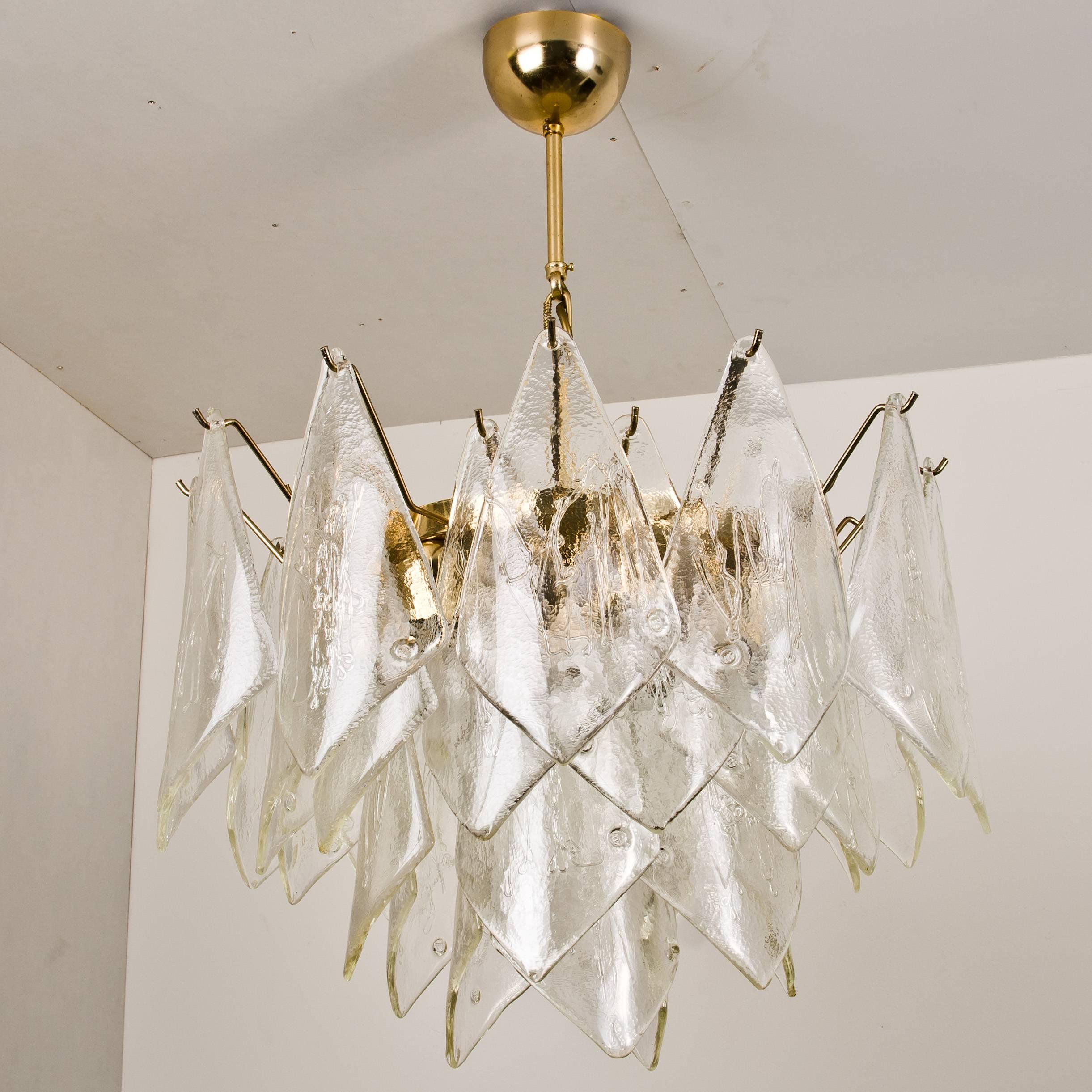 A very beautiful and elegant vintage chandelier, manufactured by Kalmar Austria in the 1960s. Lovely design, the chandelier has six sockets and two layers of stylish textured ice glass leaves (33 pieces) dangling on it.


The rod can be adjusted