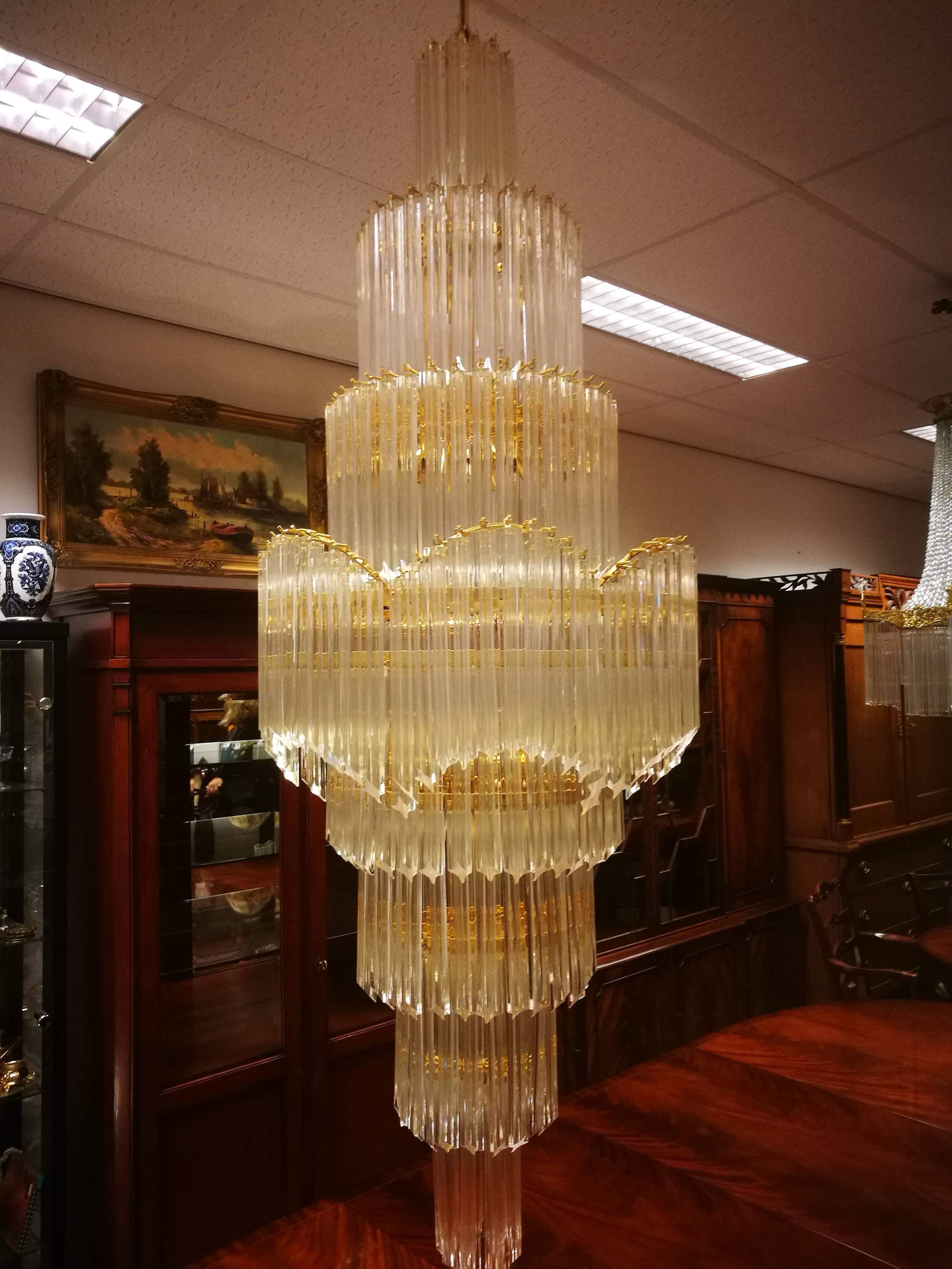 A magnificently, enormous orginal Italian Venini chandelier. An Italian design manufactured in circa 1970 (late 1960s and early 1970s). Clear triedi Murano glass tubes on polished brass frame with a brass chain and canopy. A true work of art.