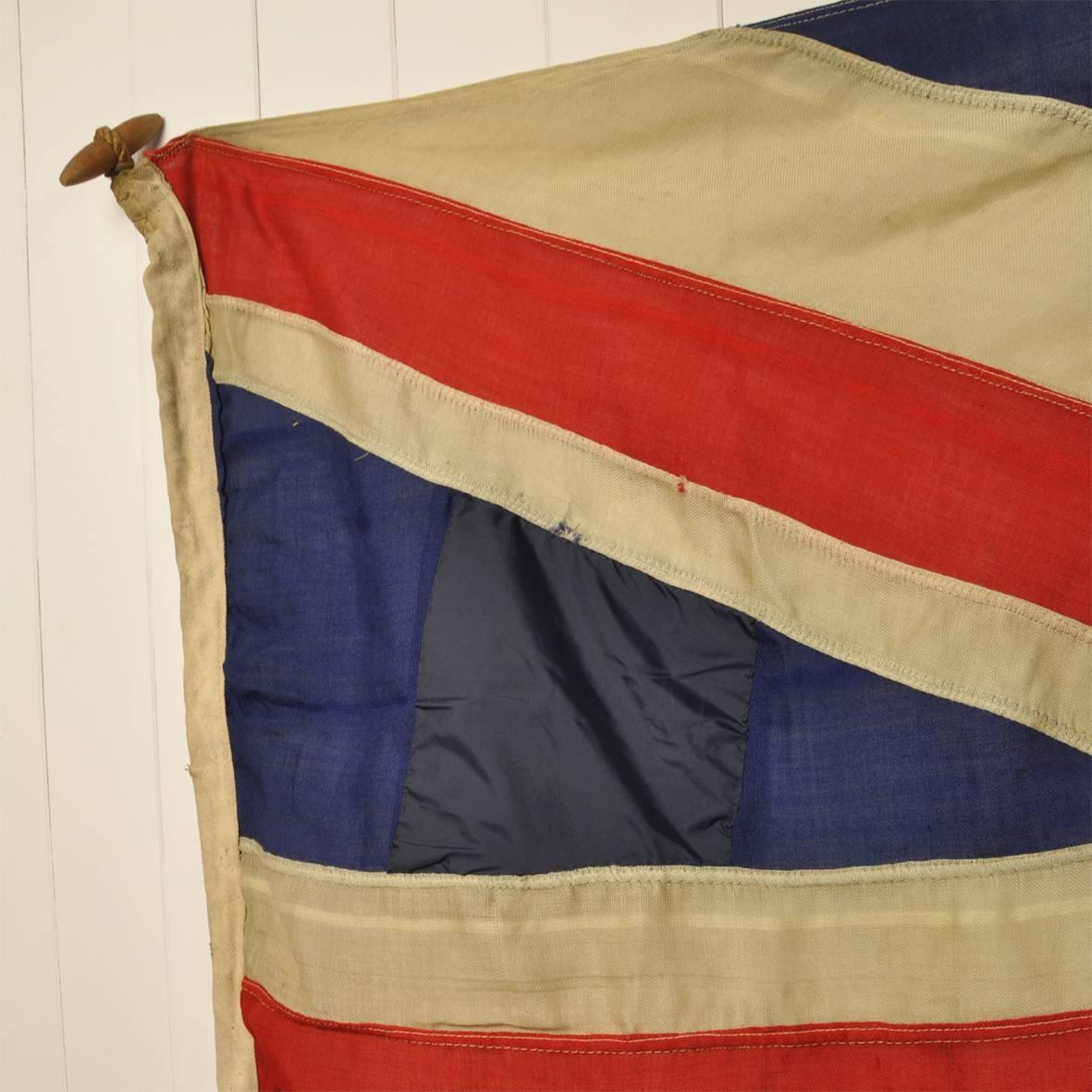 This large flag came out of a Scouts club and is believed to be 1940's.

Condition wise it is in by no means perfect condition. There are a few holes and it has two blue patches on the left and has a darned red patch, middle left.

So it does