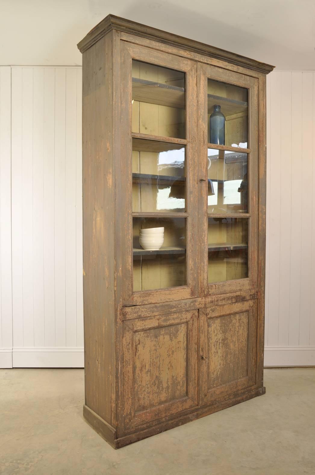 Sourced near Marseille, South of France, this painted bookcase is circa 1880. 

It has been washed back to reveal these older layers of paint which produces this lovely finish.

Some of the glass is original with a lovely texture, having been