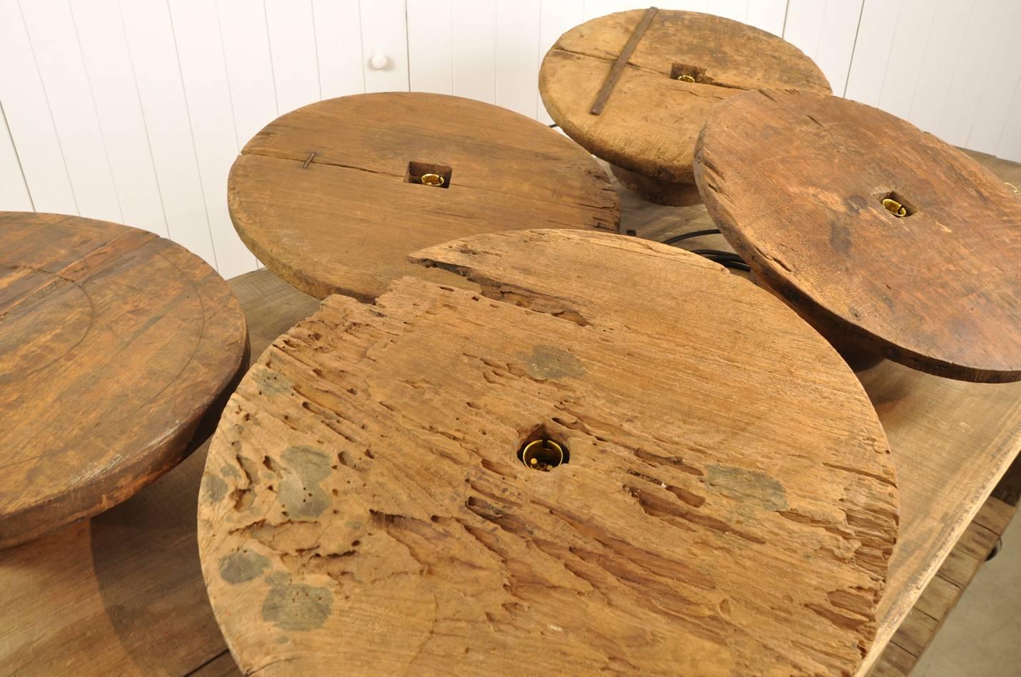 Something a bit different. 

These are circa 1900 wooden moulds for forming Asian Hats - you can see that in the shape.  The wood is teak.

We have converted these into these fun pendant lights.   Sold wired with new brass fittings, black