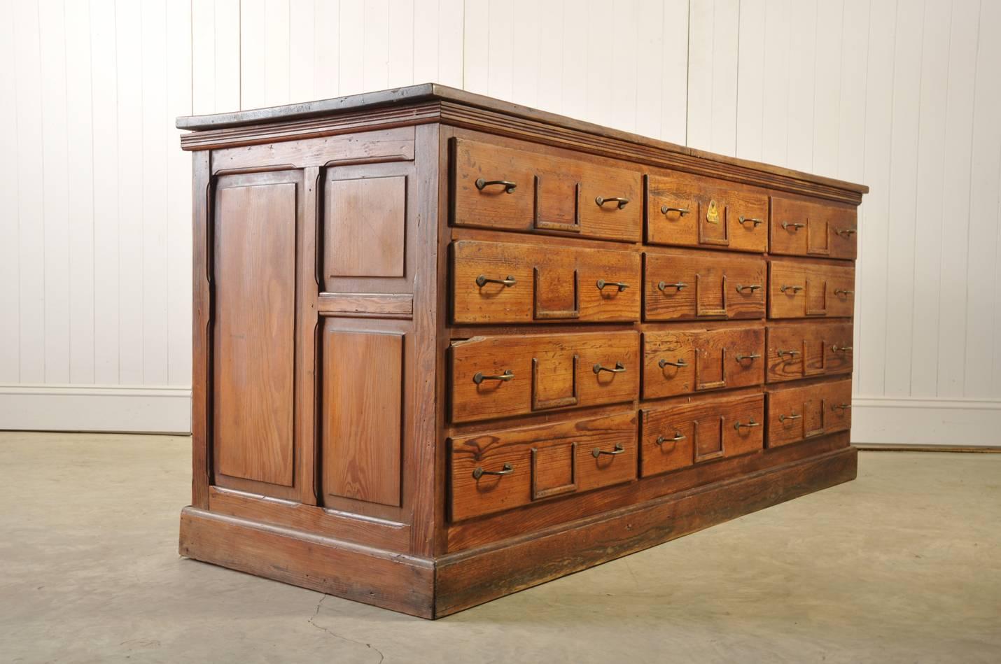 This sideboard was sourced from a grain store in mid France, circa 1900. 

Like many pieces of industrial furniture this has not only been used for filing, but also as a workbench over the years. You can see evidence of this with the marks,