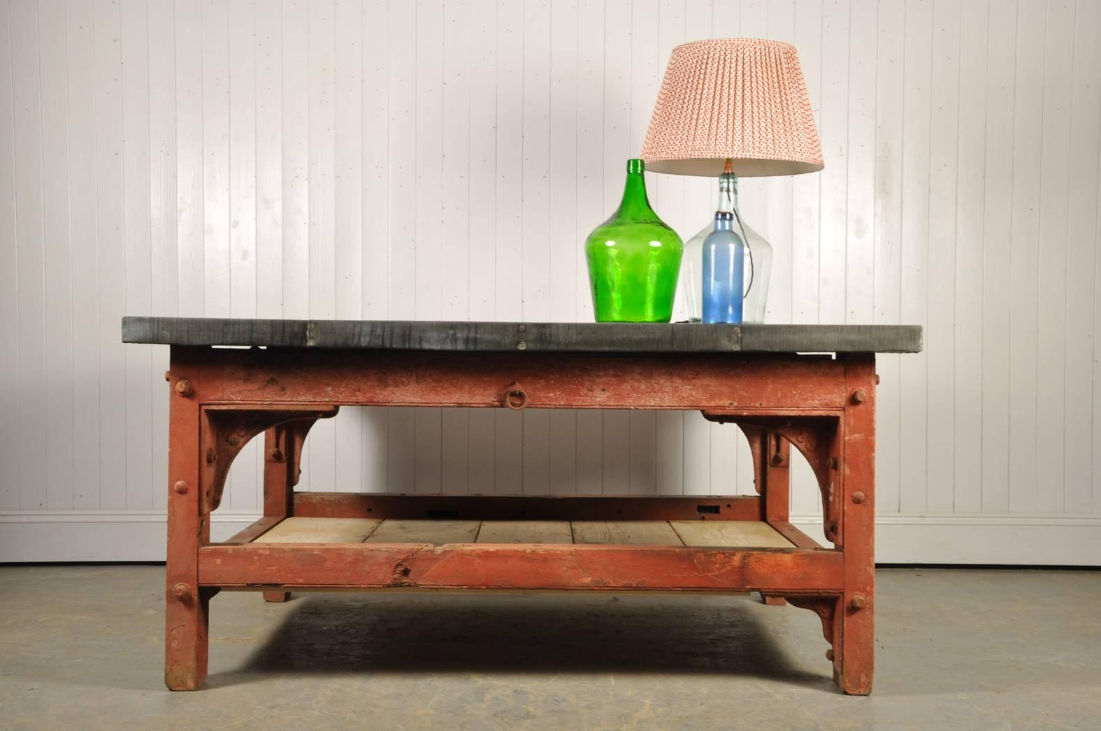 Very excited to have our hands on this stunning table. 

The oak base was originally sourced from a saw mill, it was part of a band saw, circa 1910. It retains most of its original red paint which has a wonderful patina and natural distressing.