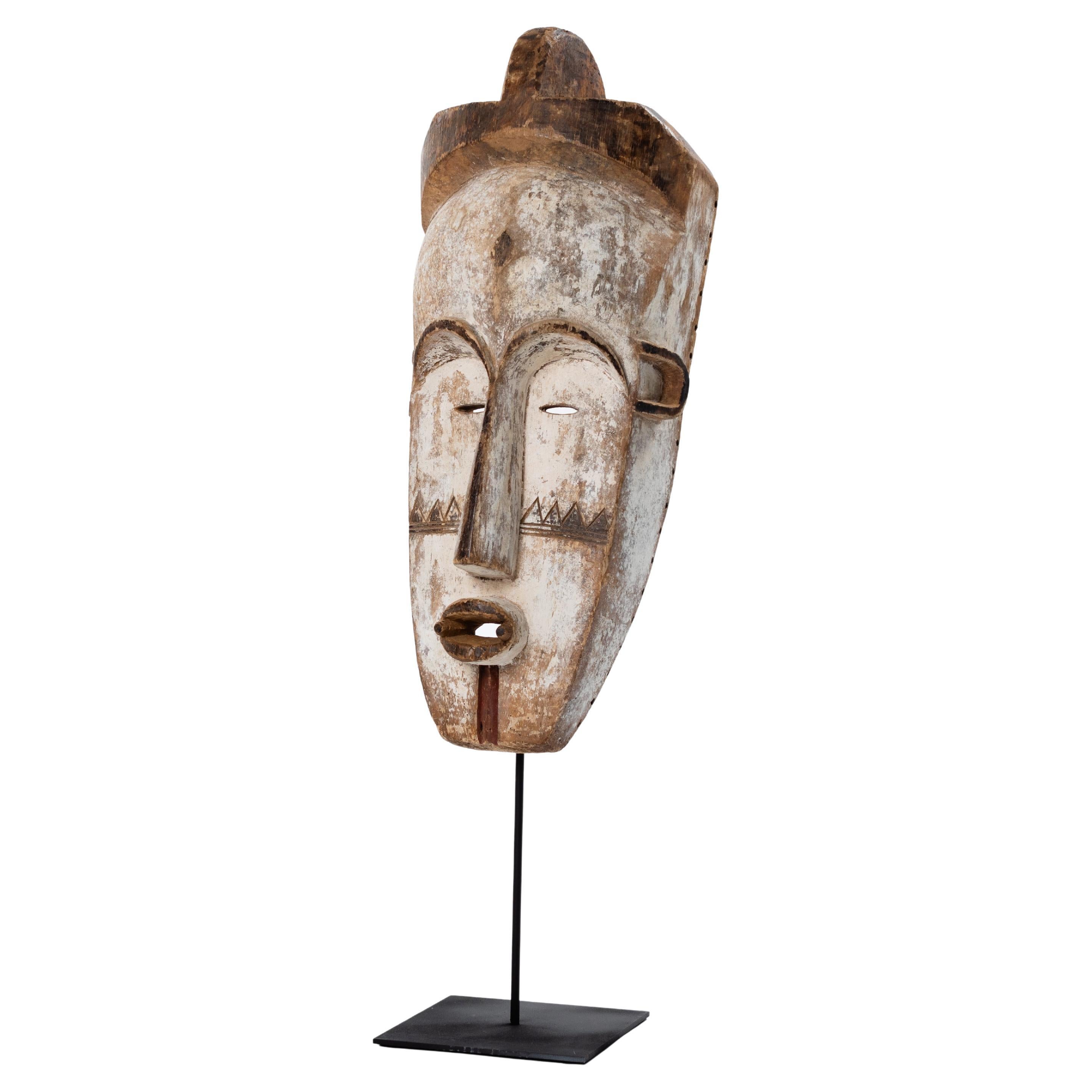 Gabonese Tall Wooden Tribal Fang Mask of Ngil Brown, Creme and Red Colored Gabon 1970s For Sale