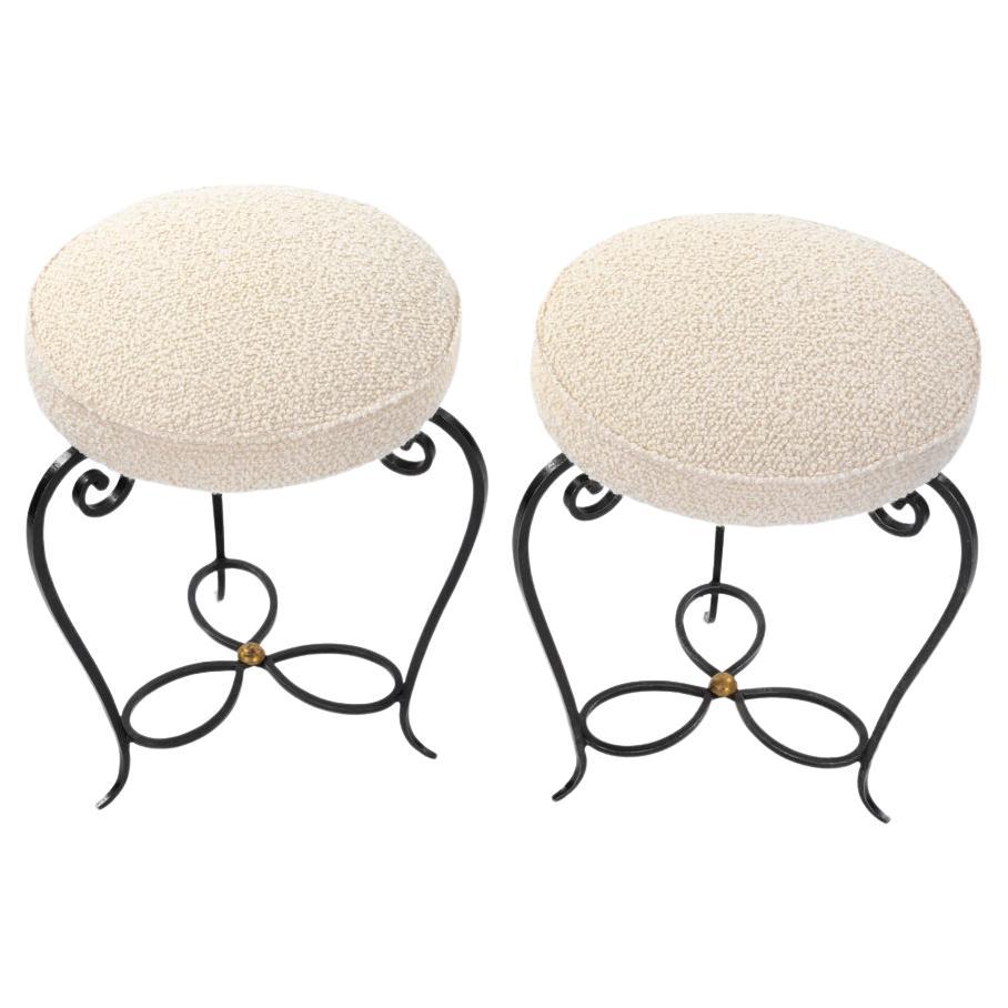 Pair of delicate forged Art Deco iron stools - offwhite colored Bouclé fabric France 1930-ies.

The stools each stand on 3 legs that curve down slightly and elegantly, forming a volute towards the seat.
The 3 legs are connected under the seat with a