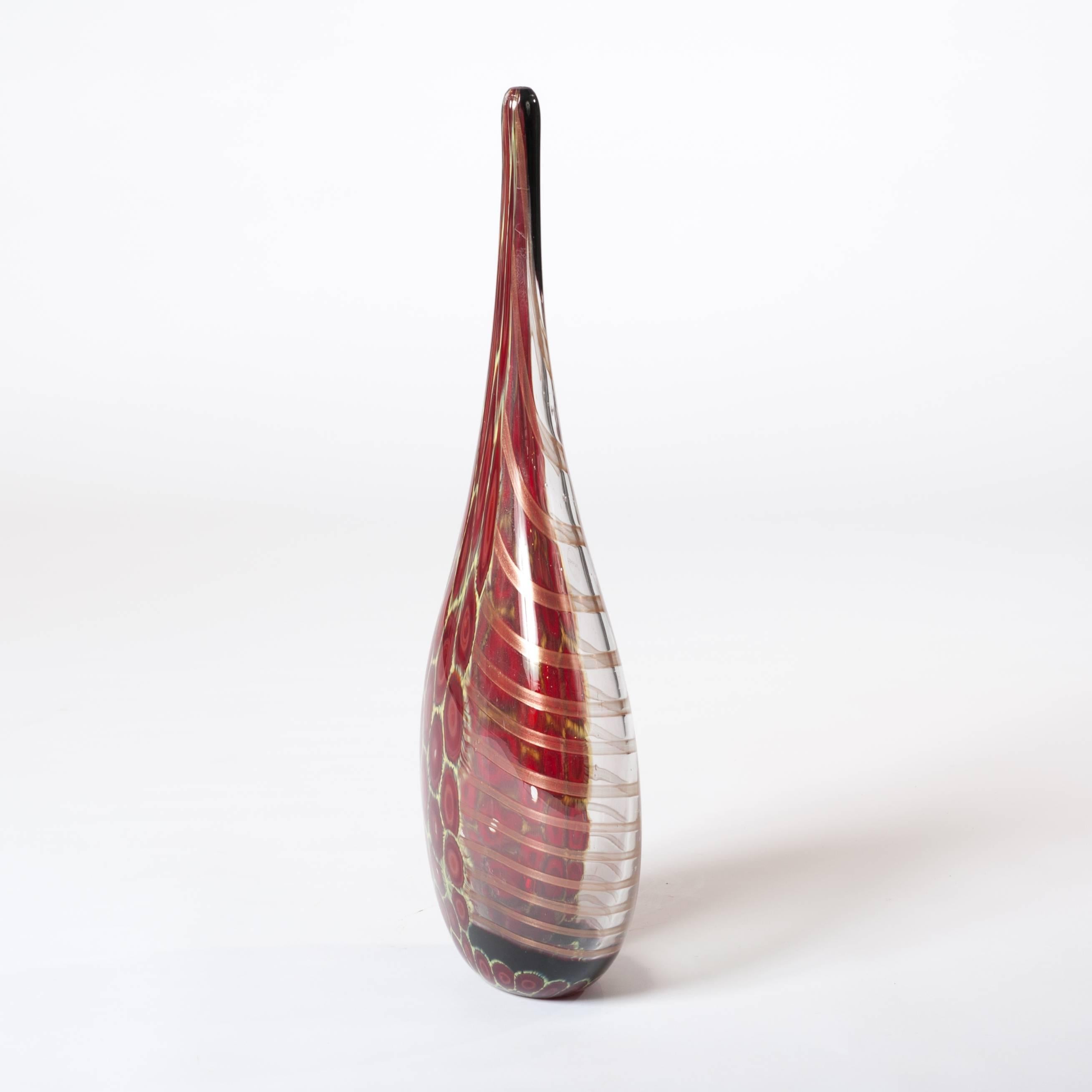 Elegant and tall bottle-shaped Murano glass vase clear glass, dark-red and yellow murrhines on one side and on the other side metallic-cognac colored stripes.
Handsigned: I Muranesi - Limited Edition - 1/1.