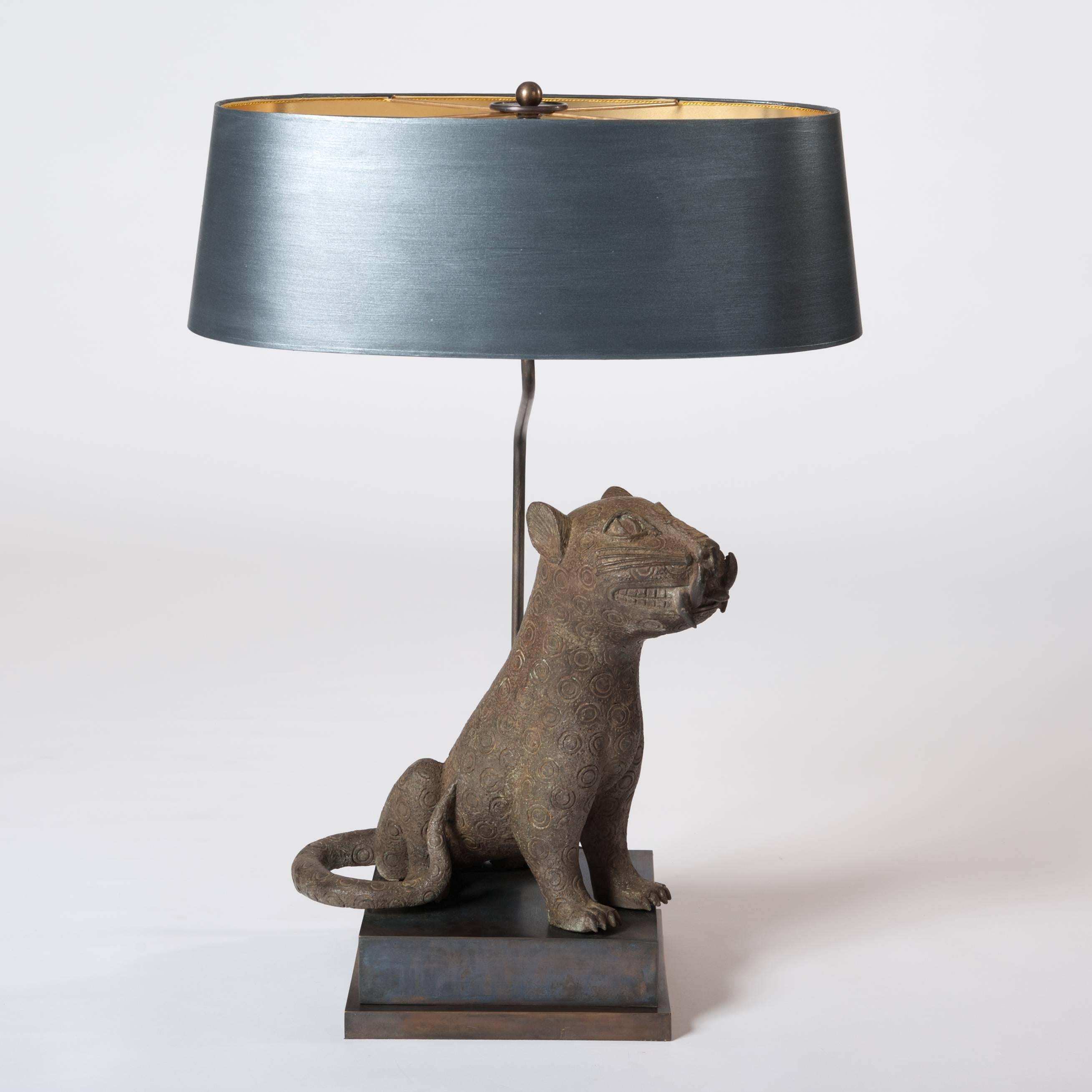 A very fine mid-century cast bronze from Benin arranged with a specially designed lamp construction and socle.
The oval lampshade is hand-painted in anthracite-grey color with fine
overlay in silver powder.