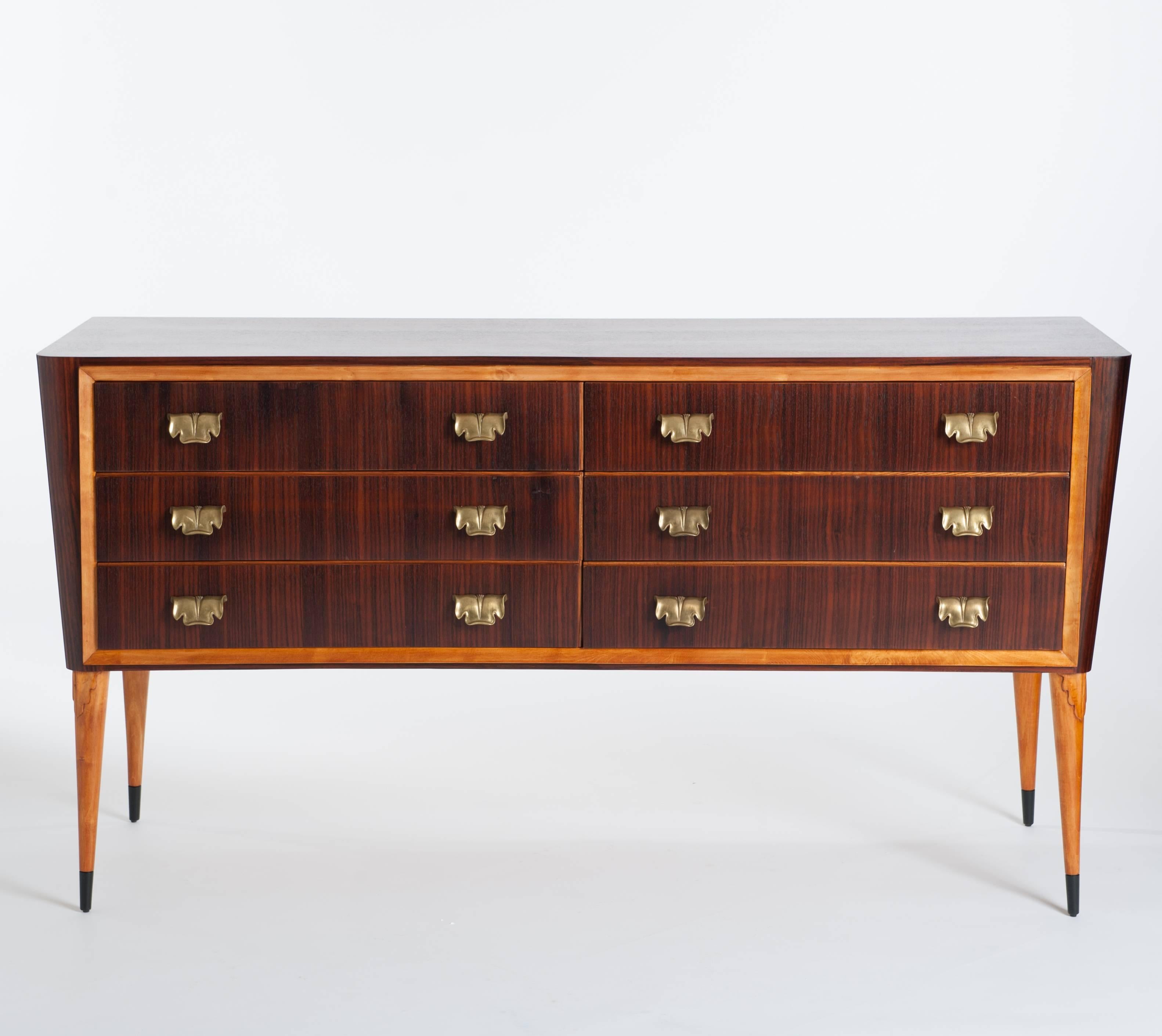 Extremely decorative and fancy 50s chest of drawers from Italy with six drawers in a wonderful choice of macassar veneer in satin matte finish.
The slightly curved drawer front is framed by blond sycamore wood on elegant high legs. 
The tapered legs