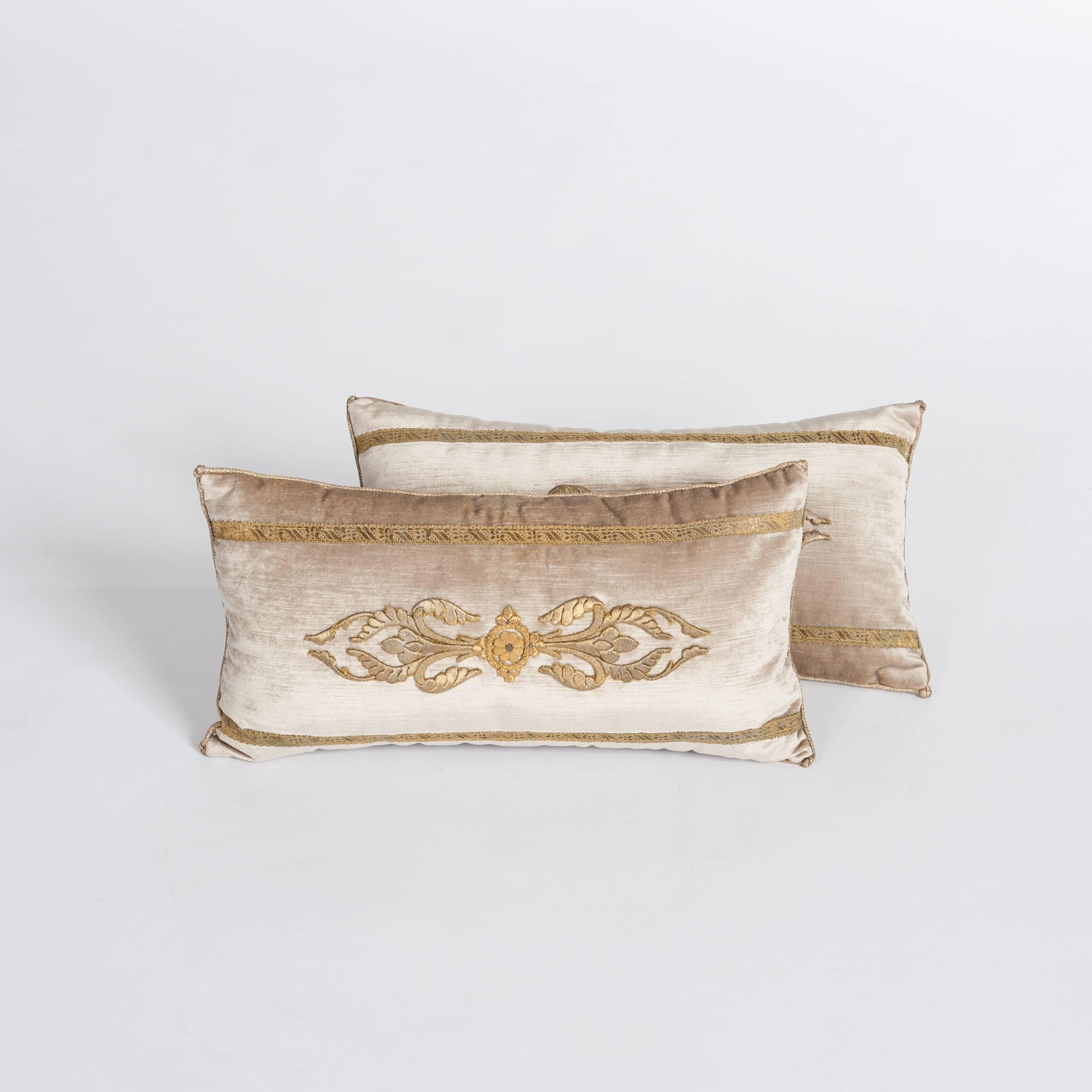 A pair of down-filled pillows fabricated with a 18th century raised gold metallic
embroidery bordered with same period gold metallic gallon on pale French
champagne velvet.
Hand trimmed with vintage gold metallic cording from Europe.


