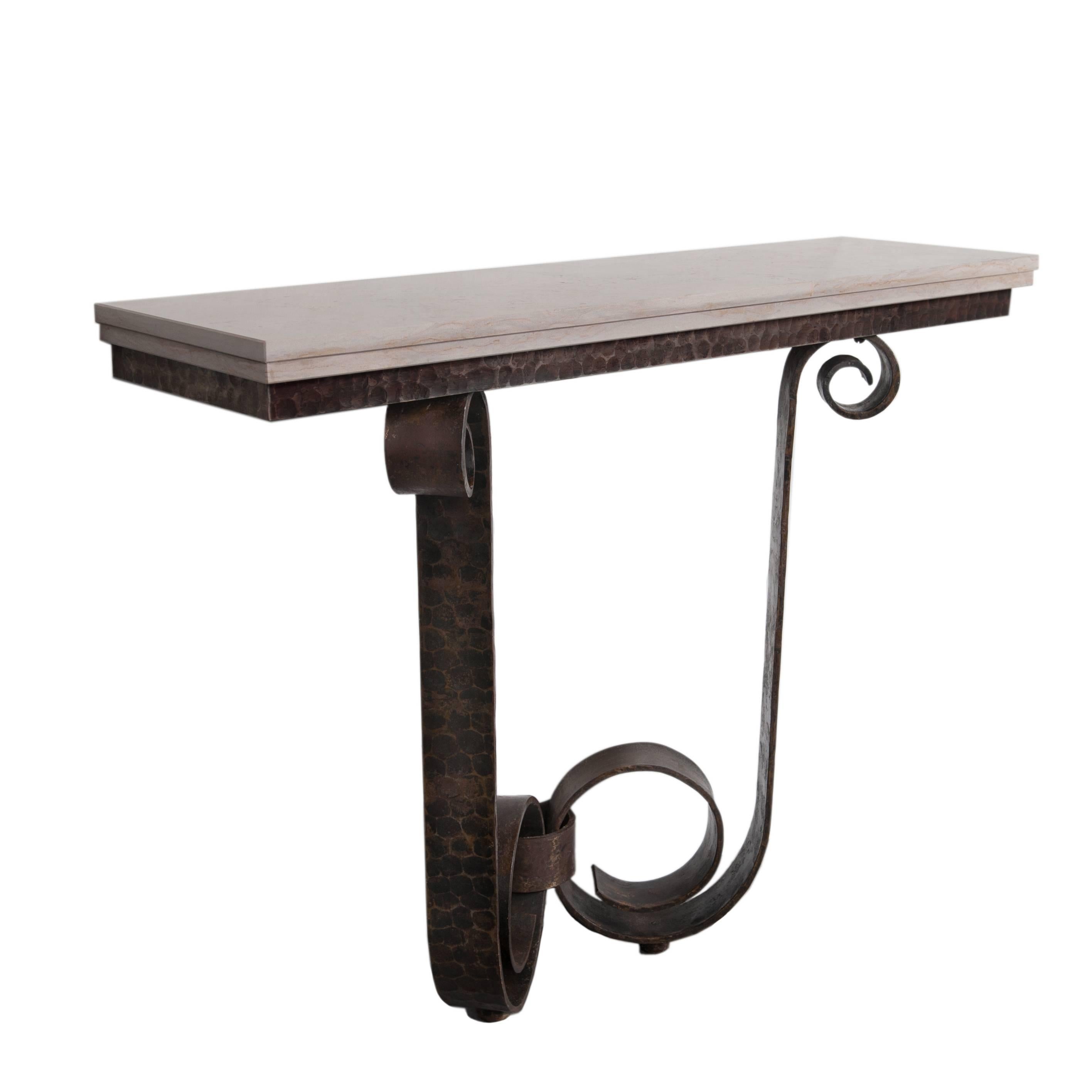 Impressive iron Art Deco console table with hammered surface.

The console table displays an extraordinary impressive look, because of its hand-forged, hammered surface and the doubled marble top.
The rusty brown-grey color of the waxed iron base