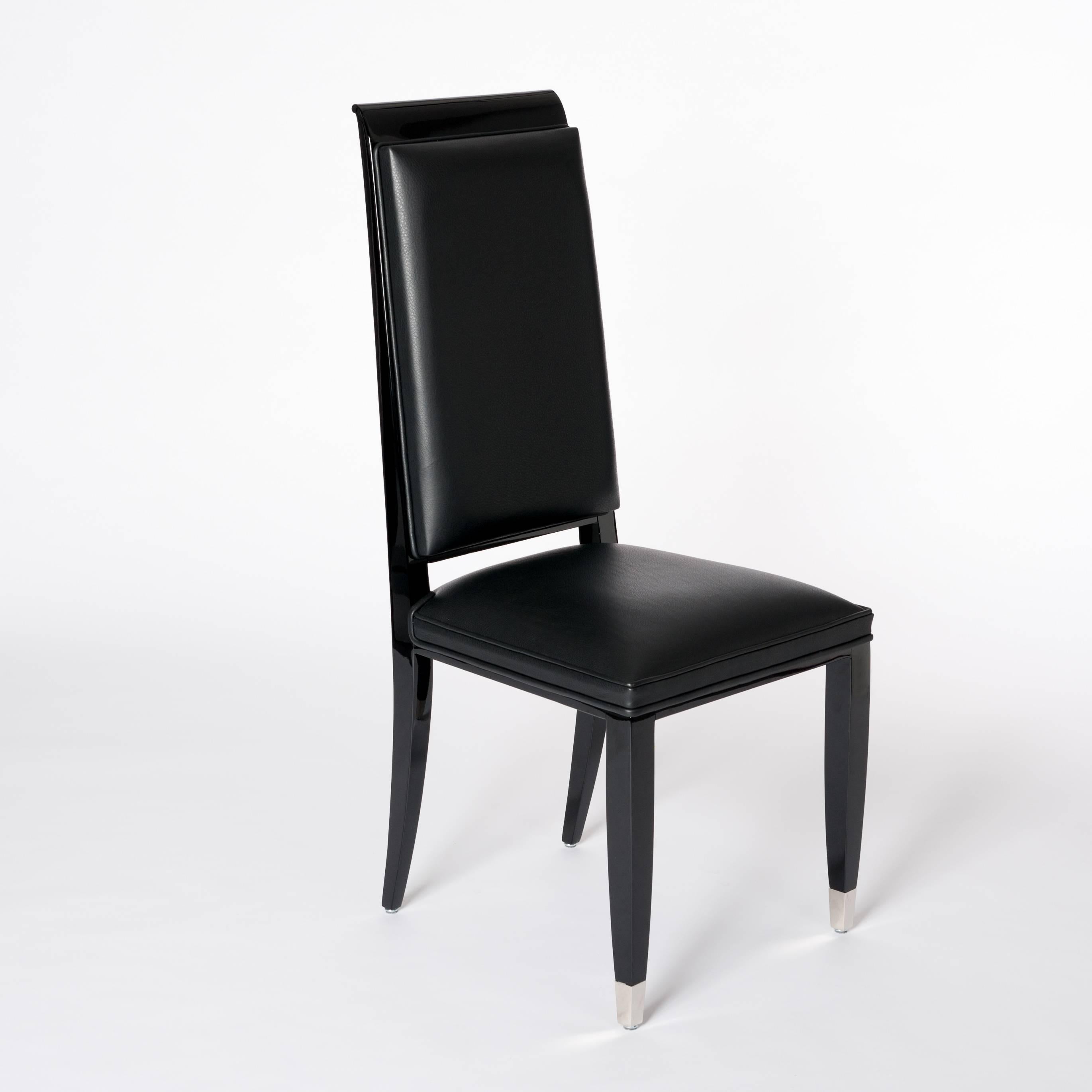 A set of four very elegant French Art Deco dining room chairs with a high backrest and nickeled
foot hoods. Completely re-upholstered and covered with a black pigskin from the famous leather company Stolz, Belgium.