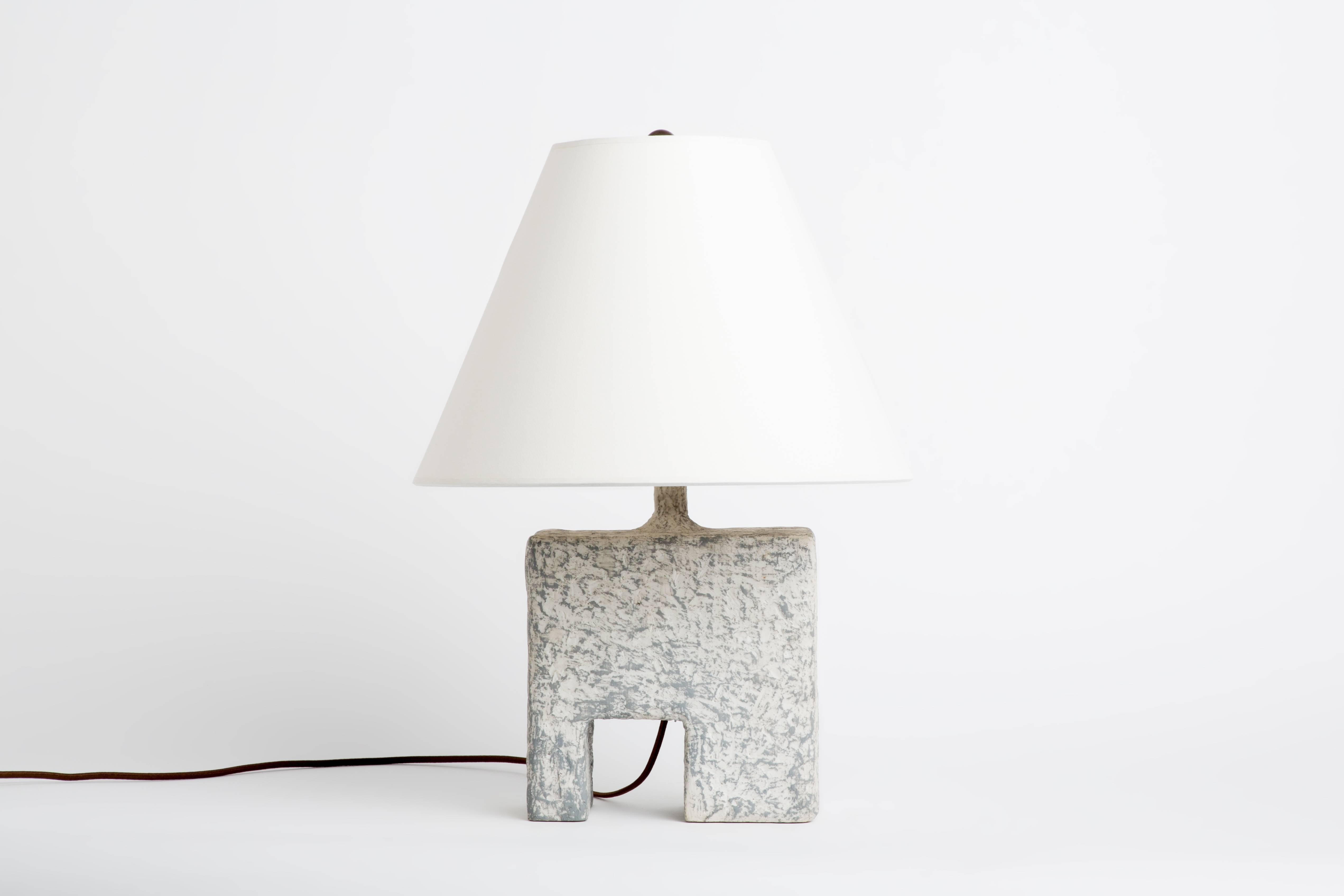 This lamp is 1 of 5 lamps of Dolatowski's cast resin table lamp series. This resin lamp is organic, modeled and textured in form. 

Wired to US standards. Shade is not included. 

Influenced by his travels in Asia and the Middle East, Dolatowski’s