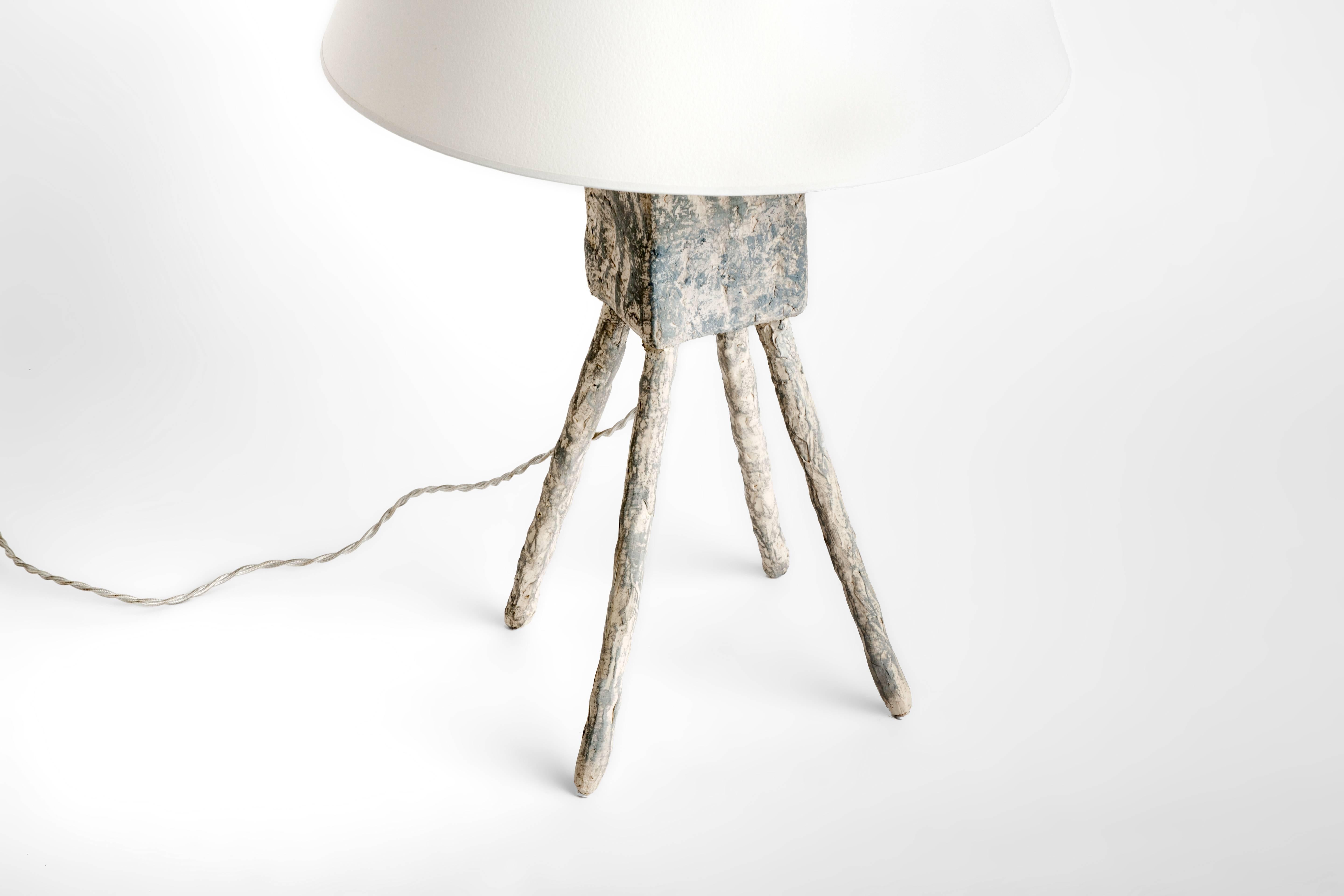 The Morceau lamp is 1 of 5 resin lamps of Dolatowski's cast lamp series. This resin lamp is organic, modeled and textured in finish and architectural in form. 

Wired to US standards. Shade not included.

Influenced by his travels in Asia and the