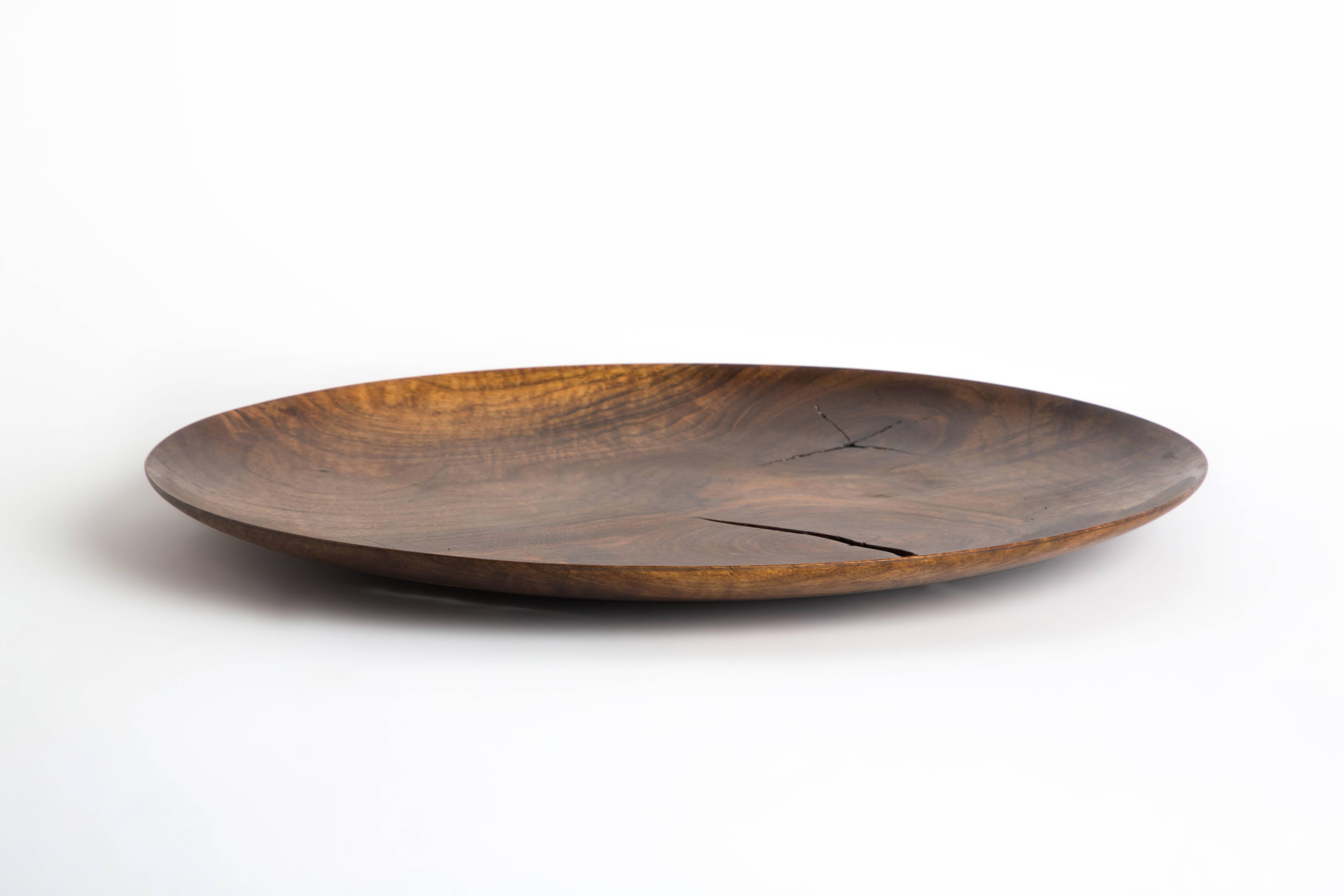 Made from a large slab of French Walnut, this is a unique and one-of-a-kind edition from Erik Gustafson. This tray has a shallow curved lip with distinctive knotting. 

Gustafson’s inspiration stems from a love of the history of art, architecture