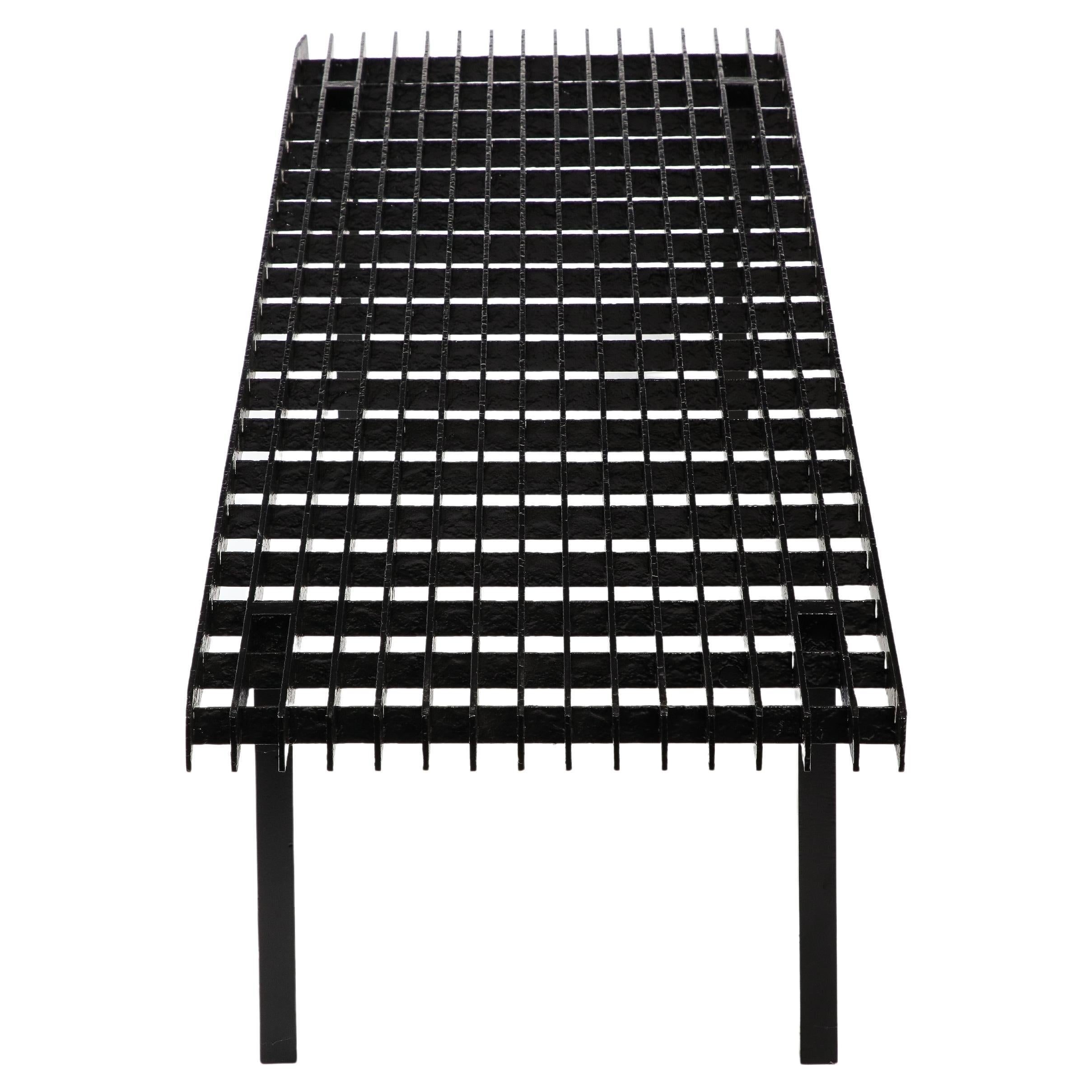 Steel slat bench made of welded steel bars, enameled in black.
