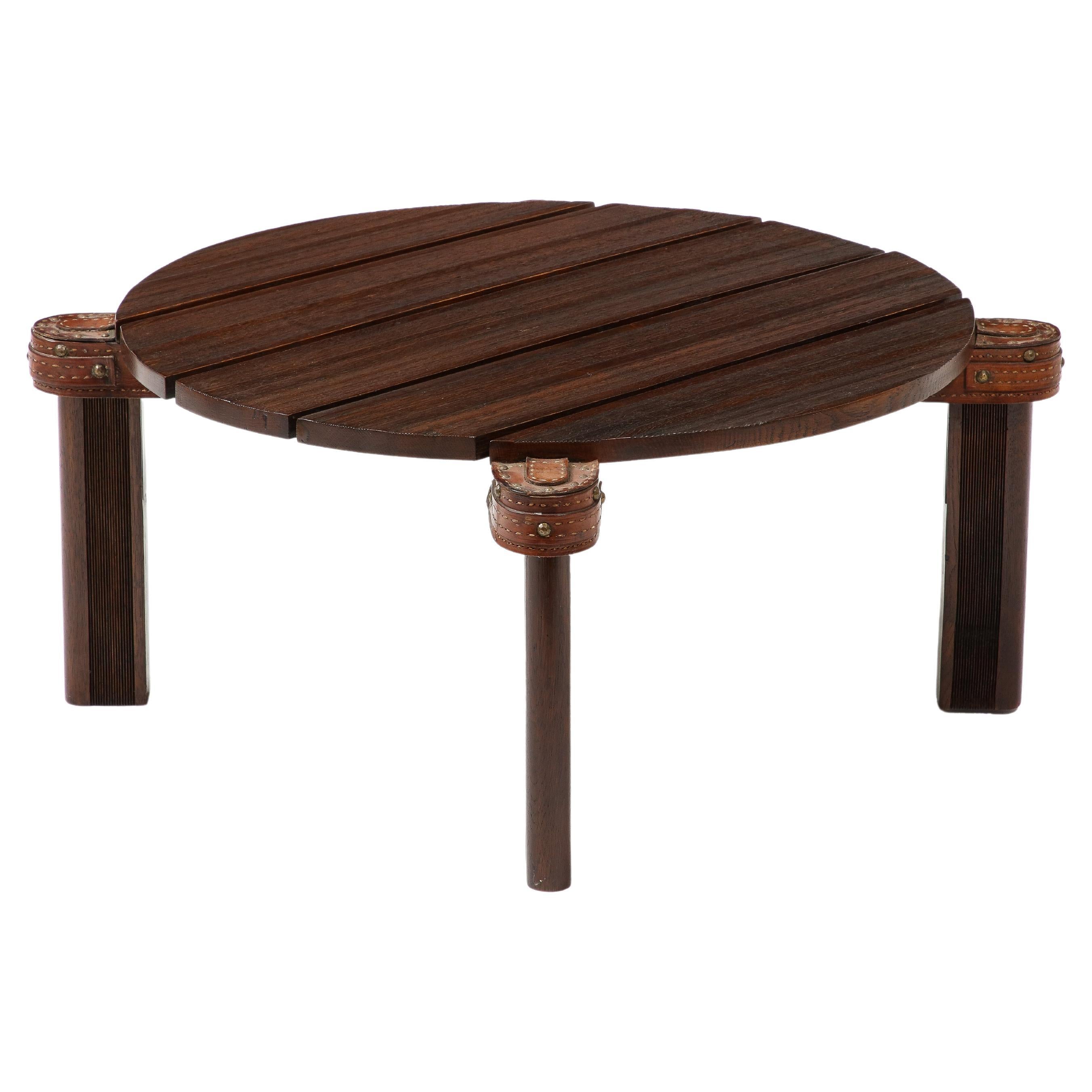 Elegant reeded table by Jacques Adnet with leather and brass nail details.