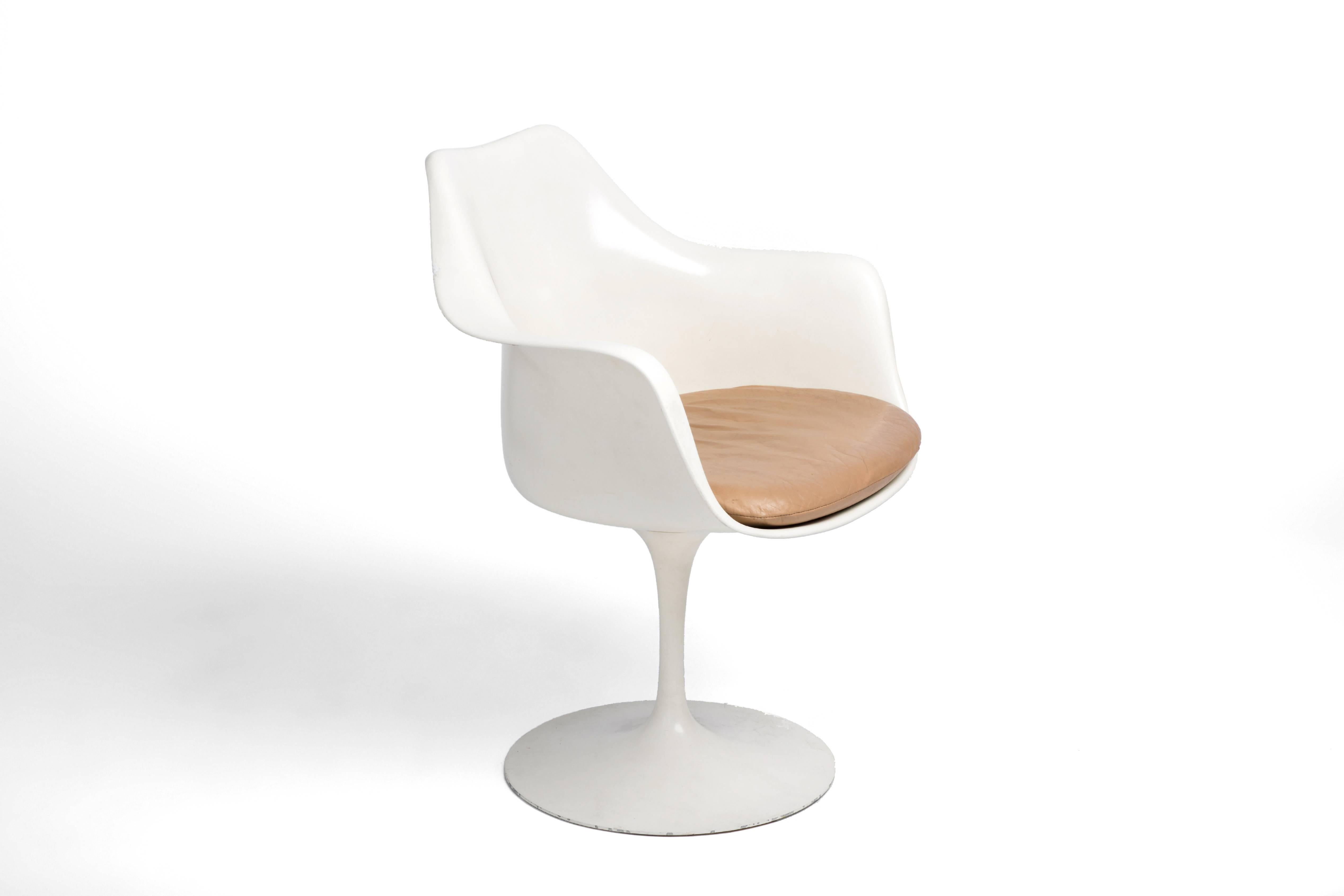 Four identical tulip chairs, structurally sound. 

Original warm white finish.

Caramel leather seat cushion can be recovered at an additional cost.