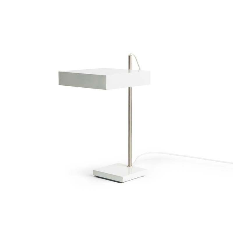 White RAAK table lamp with chrome spine. 

Shade pivots in a single direction. 

Wired to US standards, with two candelabra sockets. 