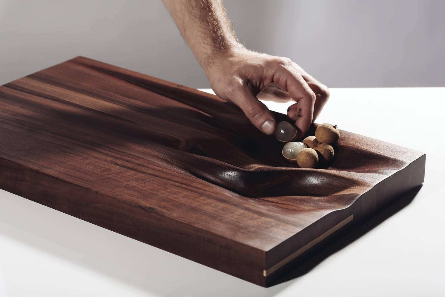 Contemporary natural cutting board by Vincent Pocsik.

Carved walnut cutting board with natural finish. 

Natural food safe oil and wax finish. 

Vincent Pocsik finds the balance between old and new fabrication techniques working in conjunction to