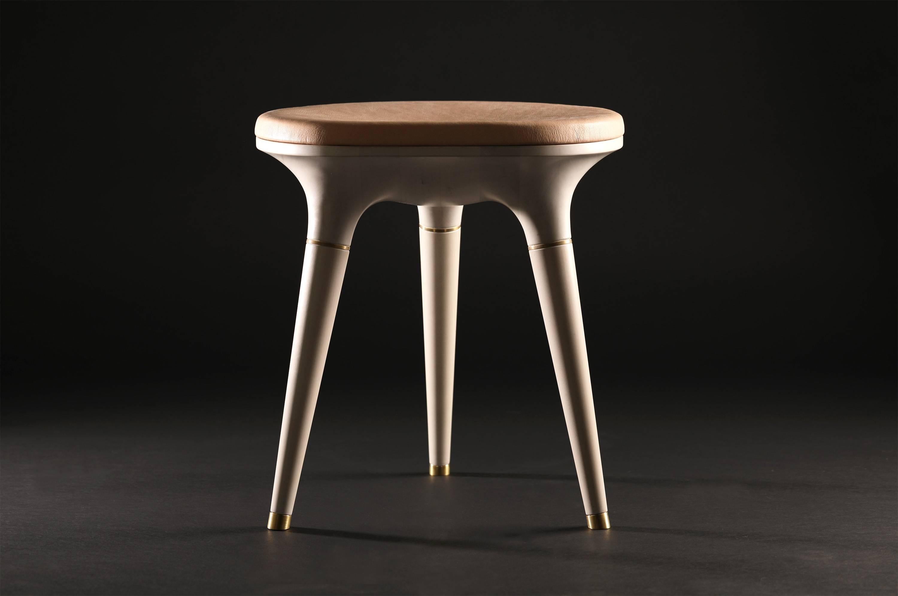 Bone Stool001 from Series 001 by Vincent Pocsik.

Carved maple stool with leather cushion top and brass accents. Shown here in a bone and natural vegetan leather top.

Vincent Pocsik finds the balance between old and new fabrication techniques