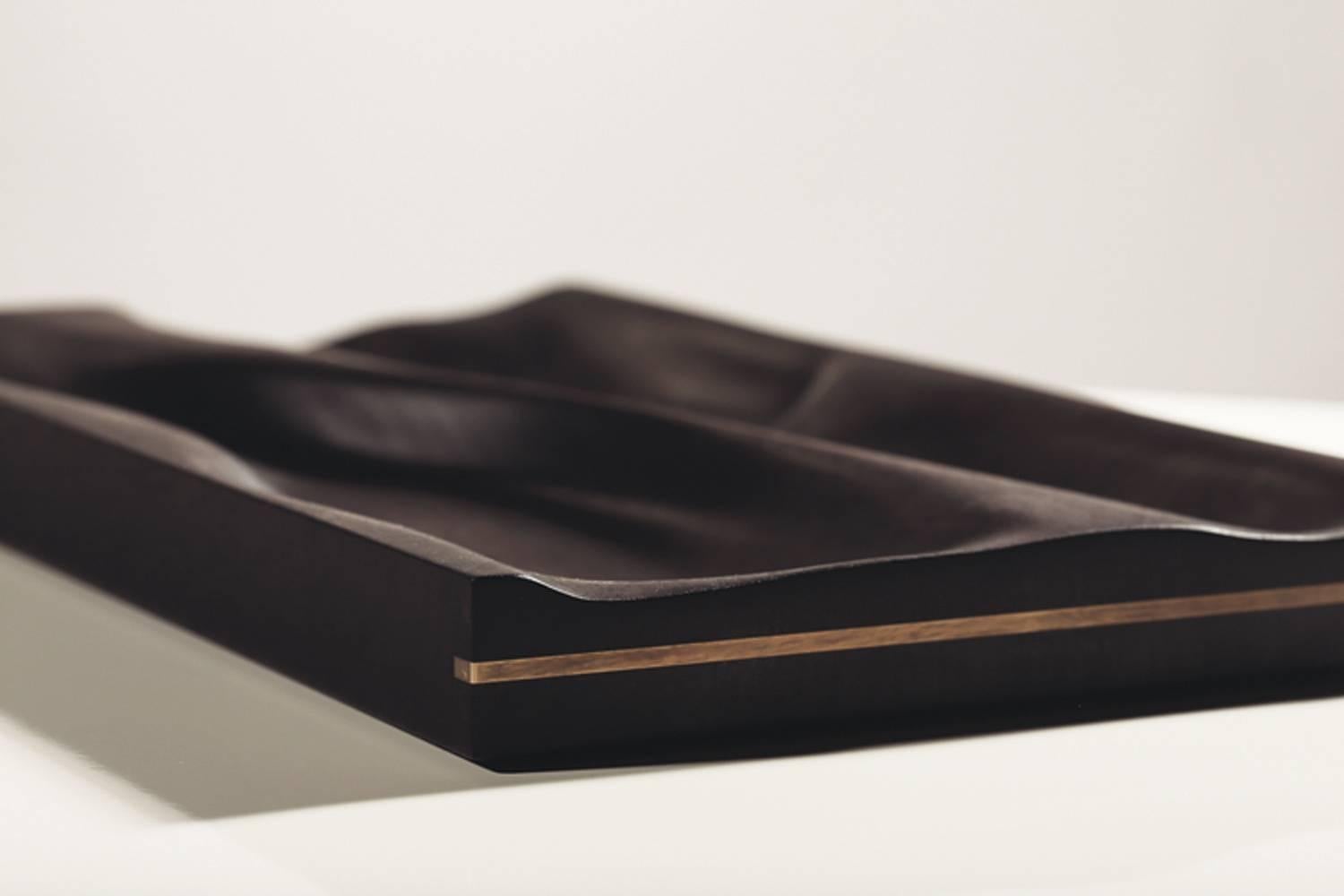 Contemporary ebonized tray by Vincent Pocsik

Carved walnut tray with ebonized finish.

Natural food safe oil and wax finish.

Vincent Pocsik finds the balance between old and new fabrication techniques working in conjunction to find an anatomical