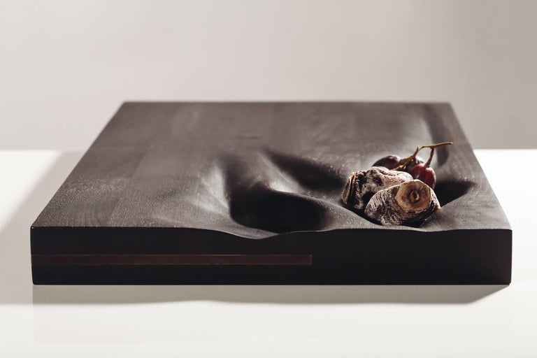 Contemporary ebonized cutting board by Vincent Pocsik

Carved walnut cutting board with ebonized finish.

Natural food safe oil and wax finish. 

Vincent Pocsik finds the balance between old and new fabrication techniques working in