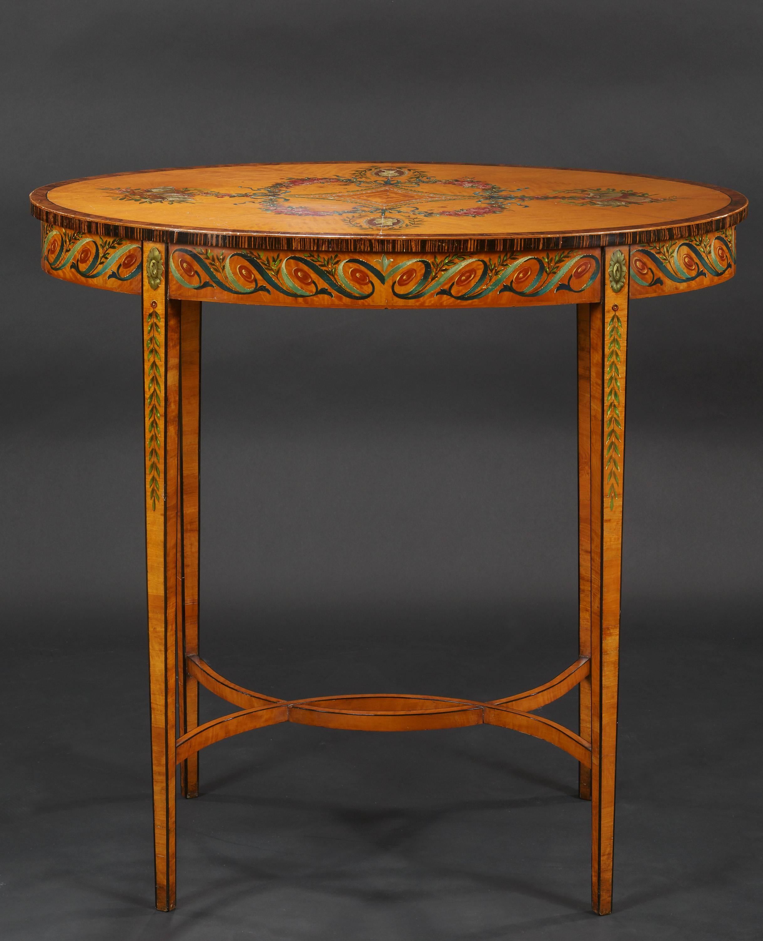 Nineteenth century satinwood and fruitwood oval polychrome painted side table beautifully decorated top with a coromandel banding on tapering supports with intertwining stretcher, circa 1870.