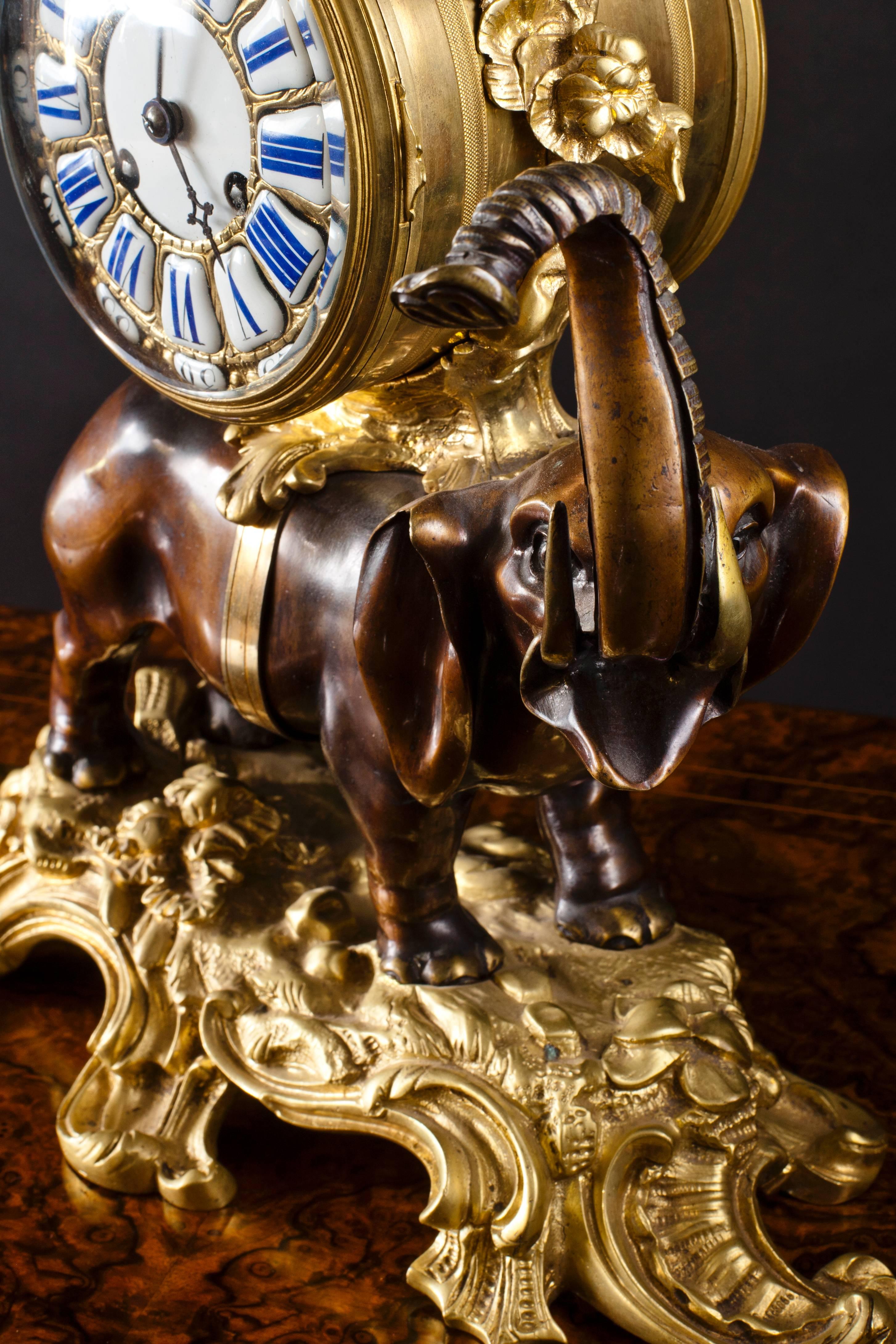 French bronze elephant clock.
A beautifully cast bronze elephant clock with raised trunk (a sign of good luck) standing on an ormolu Rococo base supporting the cylindrical clock movement. Gilded bronze dial with individual enamel cartouches for the
