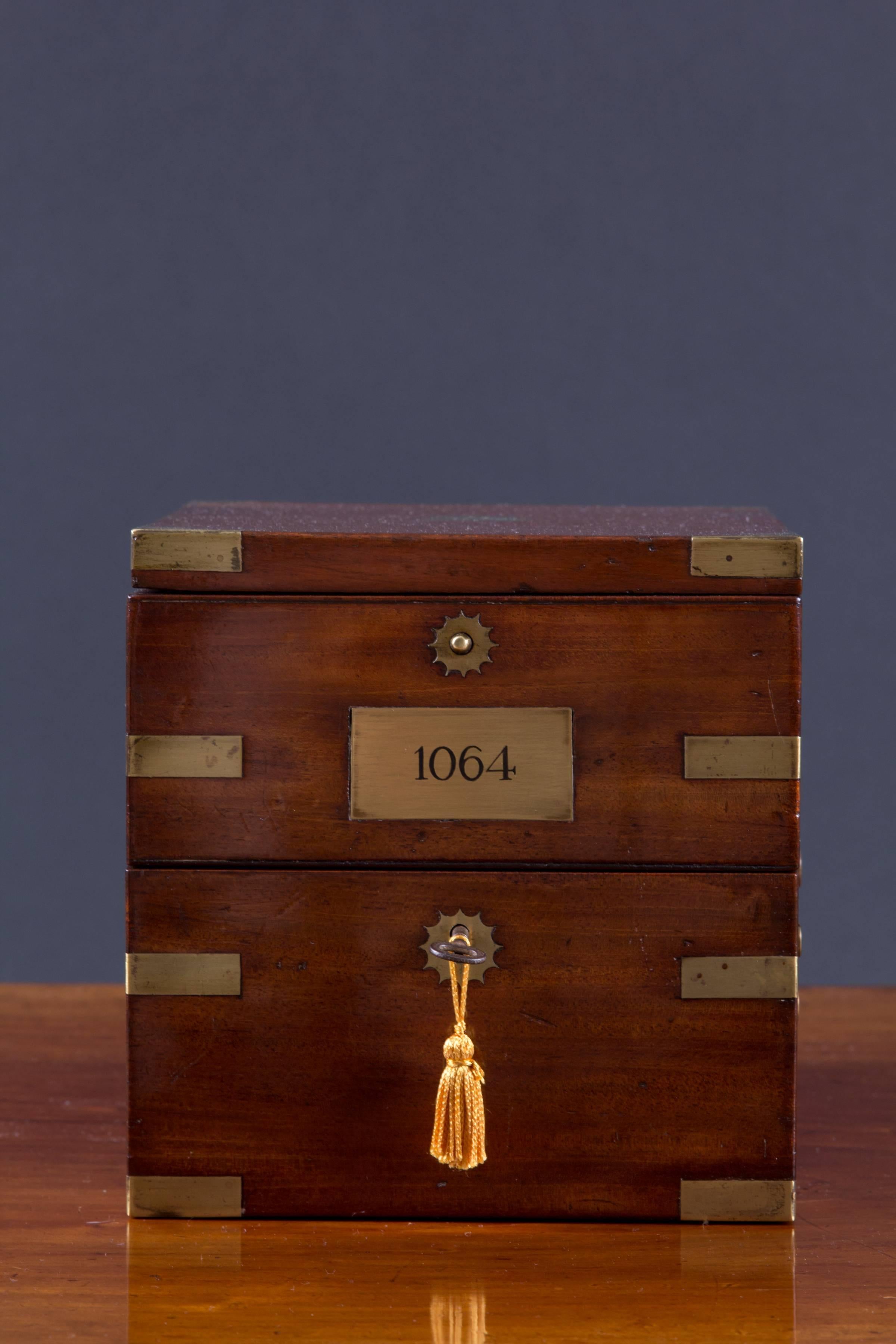 A fine two day marine chronometer by John Poole, London, No.1064, circa 1846.

Three-tier mahogany brass bound box with inset carrying handles, decorated brass escutcheon and key to the base, ‘push button’ brass knob opening to the third-tier.