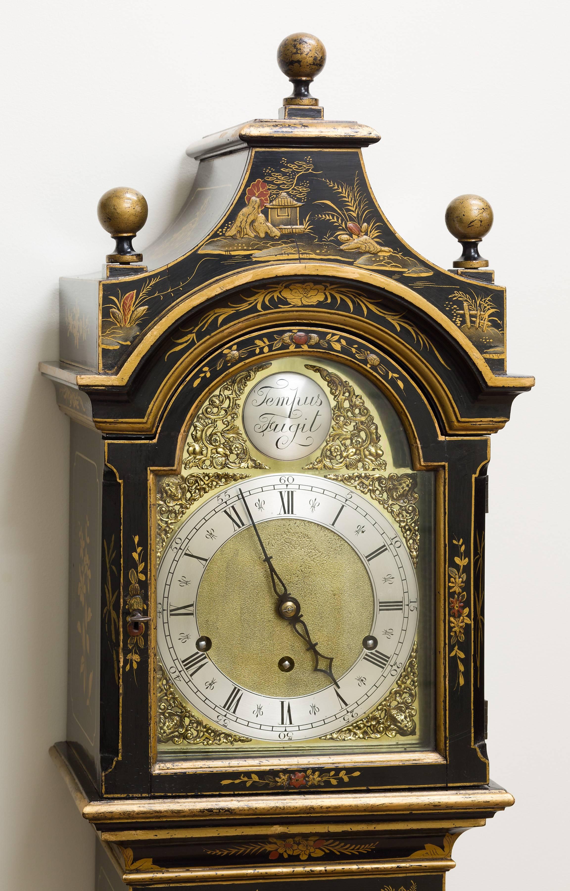 Edwardian Grandmother clock with Pagoda top and chinoiserie decoration on a black ground.

Brass dial, raised silvered chapter ring with Roman numerals and cherubs head spandrals.

Eight day quarter Westminster chiming movement with long