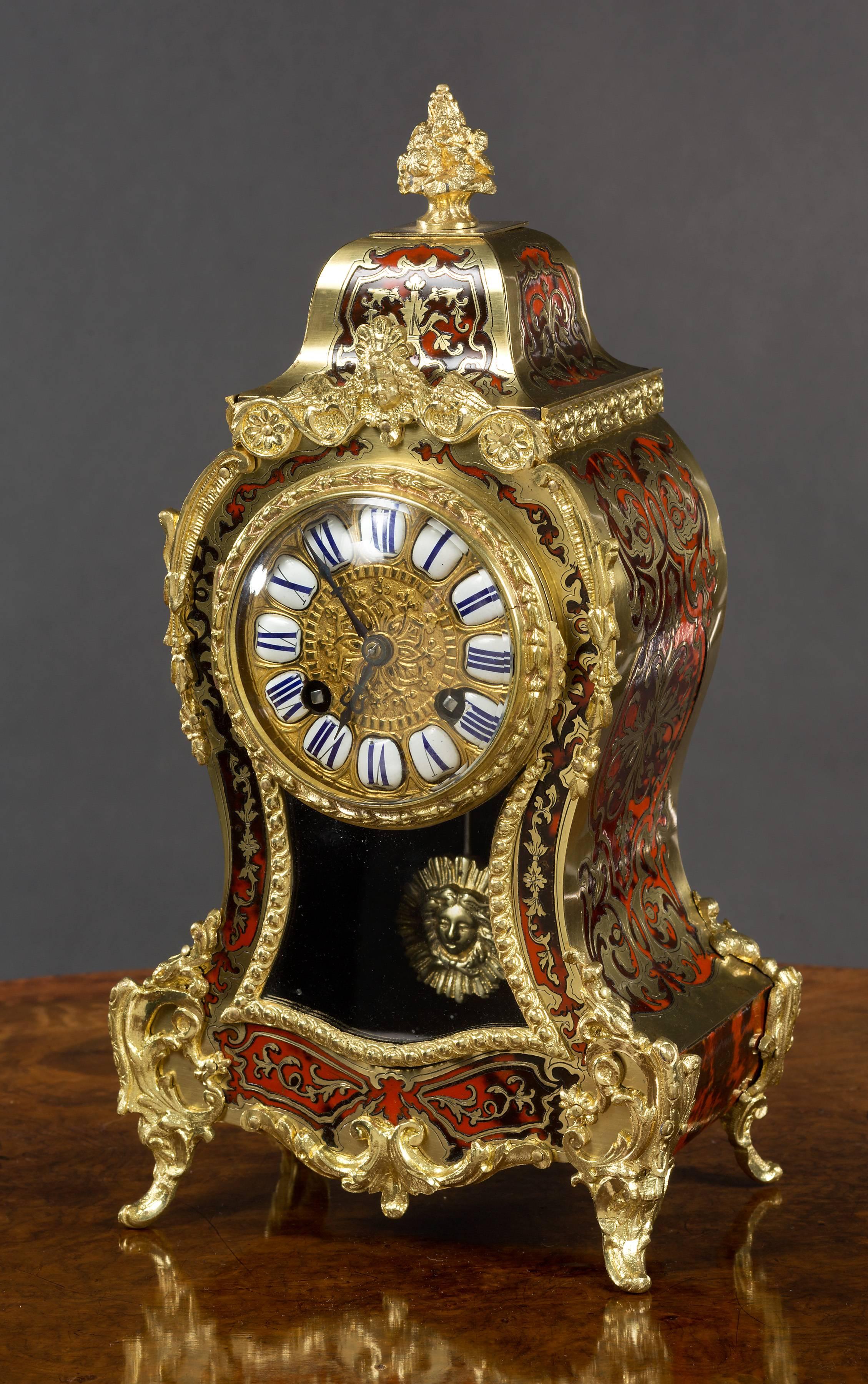 French tortoiseshell boulle clock with ormolu mounts, standing on outswept feet and surmounted by a gilded finial.

Gilded, raised dial centre with segmented enamel Roman numerals and original blued steel hands.

Eight day movement striking the