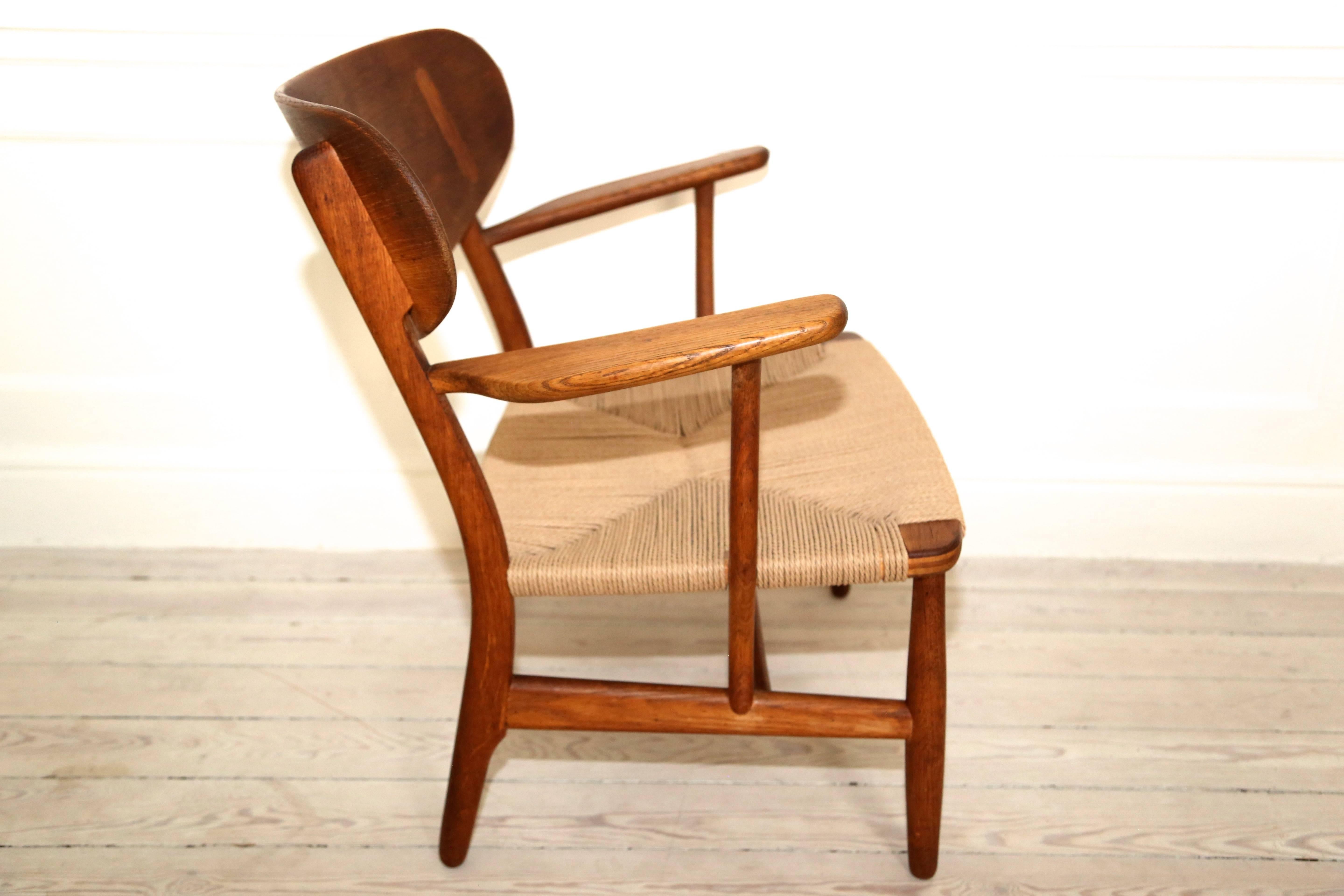Original oak armchair with wide paddle form arms and sculpted and inlaid back. New Danish paper cord seat finished by Larssons Korgmakeri. 

The chair was designed by Hans J. Wegner and manufactured by Carl Hansen & Søn, 1951.

Provenance,