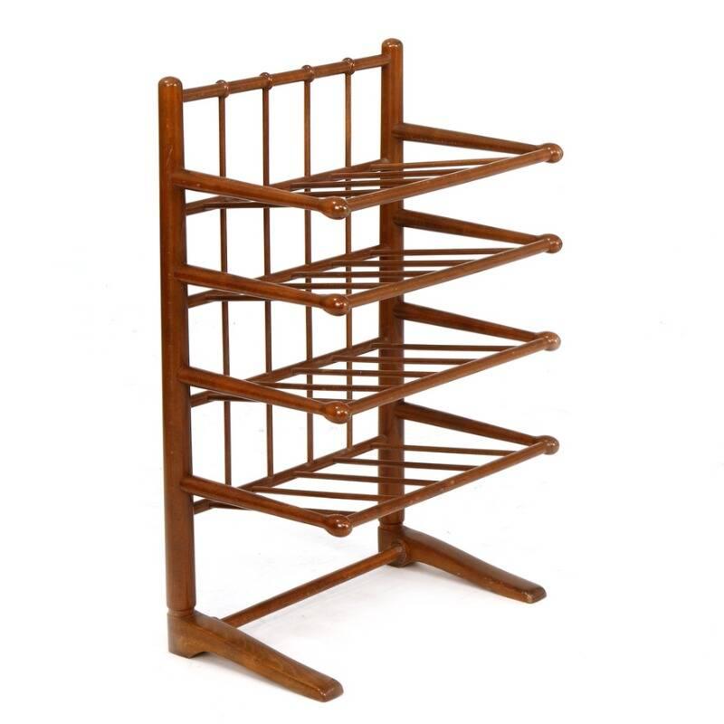 A stained beech magazine stand with four slat shelves. Produced by Svenskt Tenn.

h.76cm/29,9