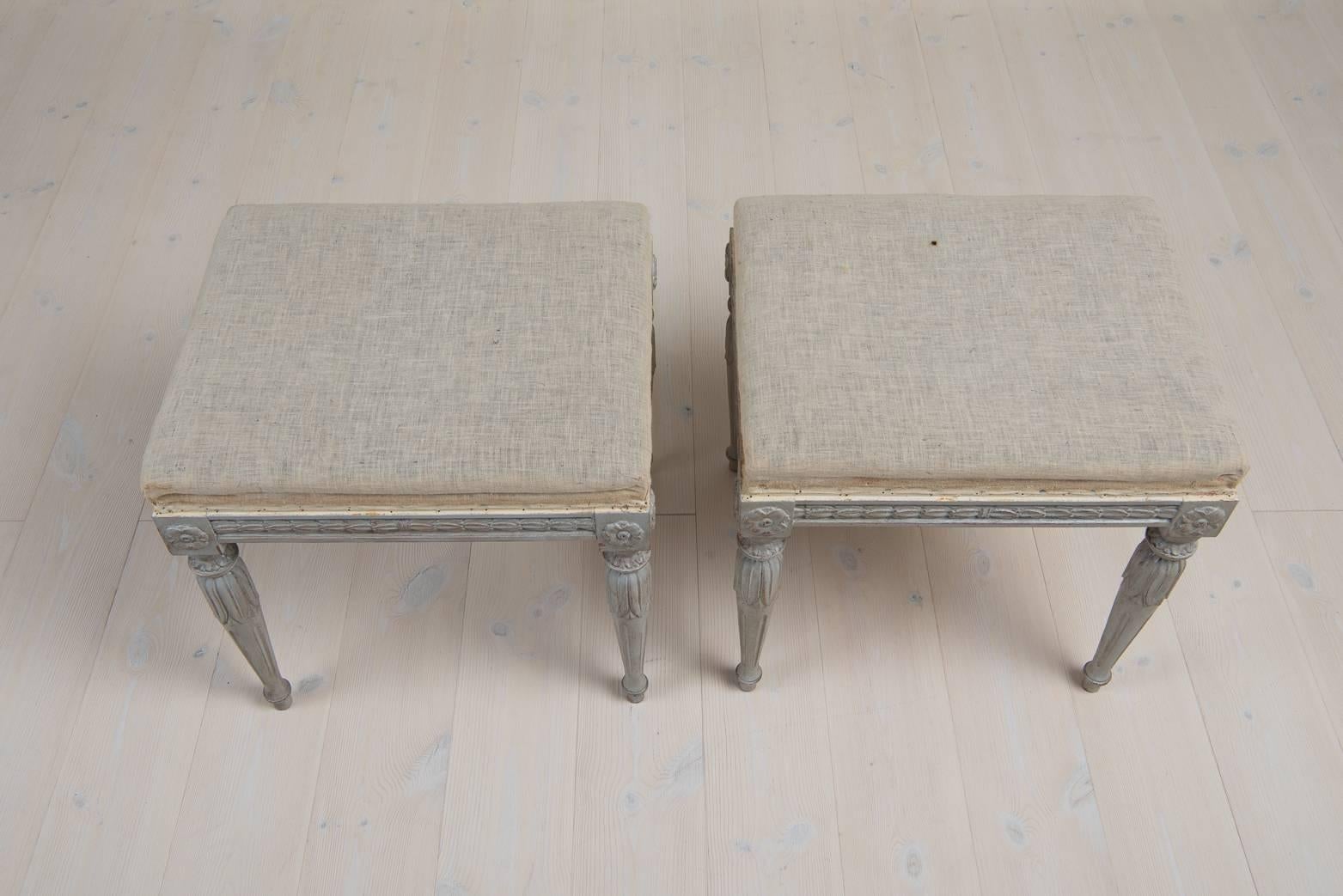 Two Gustavian style stools. The stools are richly decorated with Gustavian period elements. All decorations are carved in wood. Early 20th century, Sweden.