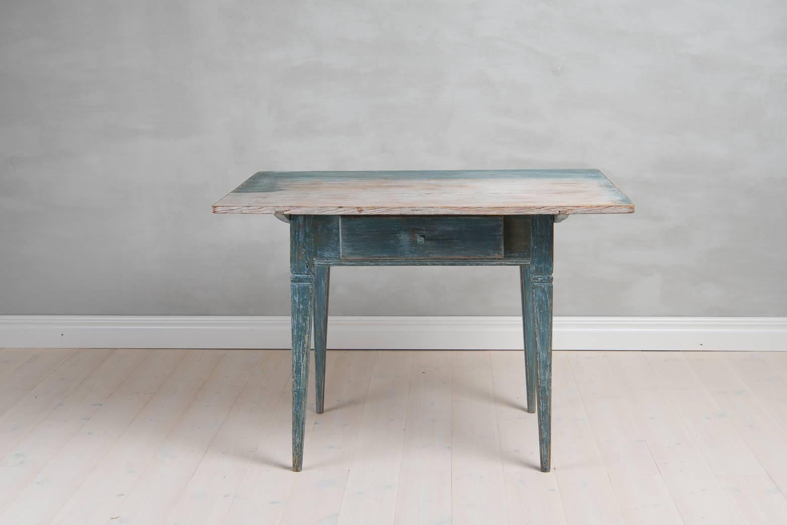 Period Gustavian table with one drawer. Straight, tapered legs. Detachable tabletop. Dry scraped to its original blue paint. Late 18th century, from Northern Sweden.
  