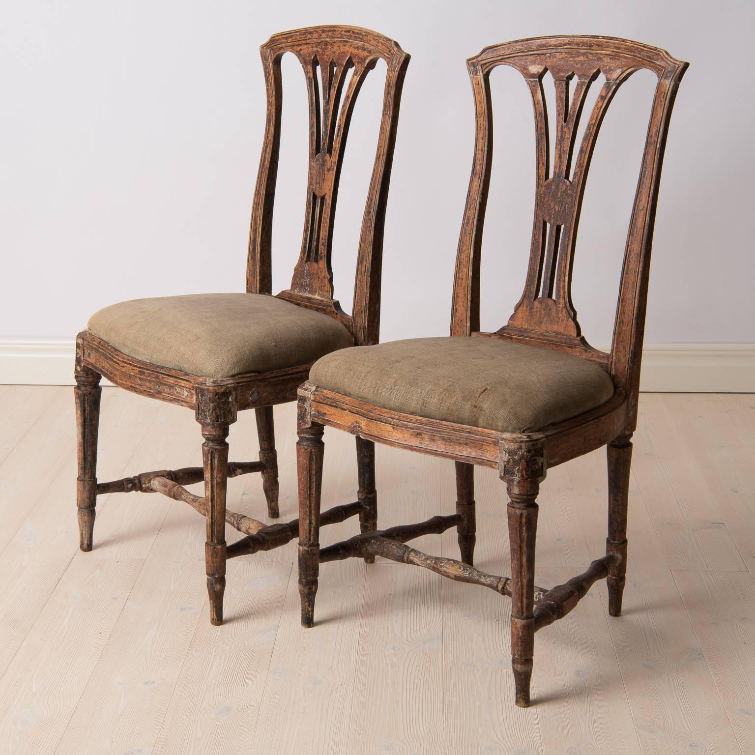 A pair of Gustavian chairs with traces of original paint. Both chairs are really nice quality as they are marked with Stockholm's Chair maker's official seal. Original seats and fabric from the 1770s. Seat height circa 48 cm.