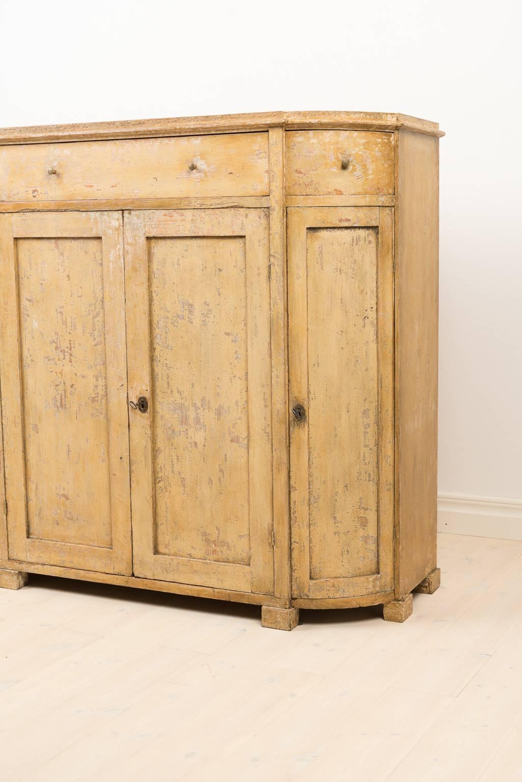 The sideboard has been dry scraped to original paint. Manufactured in the early 1800s.