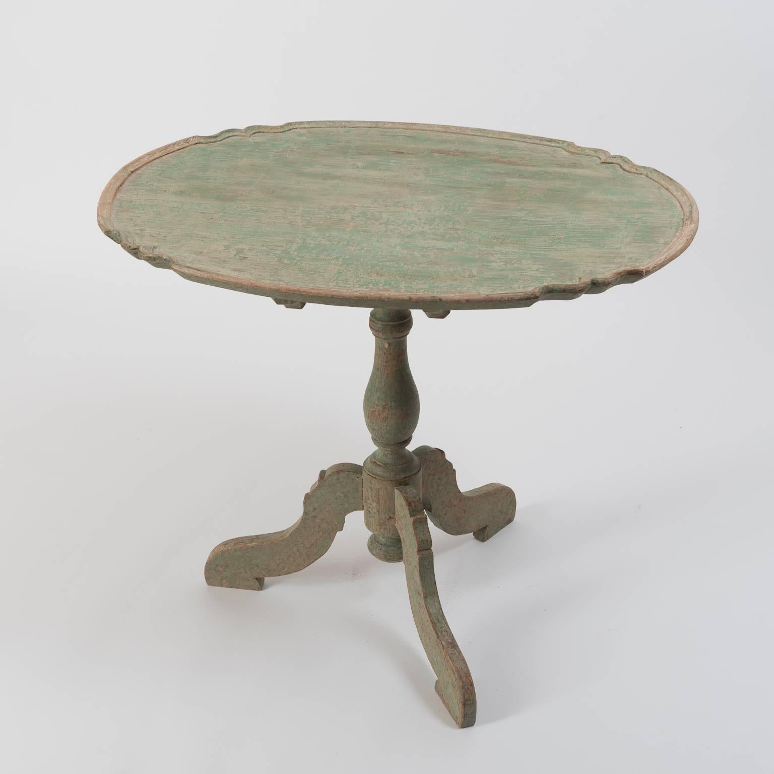 Tilt-top table with oval contoured top. Dry scraped to original paint, Sweden, circa 1770.