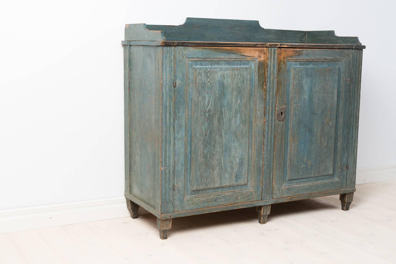 Rare period gustavian sideboard from northern Sweden. The front is dry scraped to the blue original paint. The inside in completely untouched with its original dark blue paint. Original lock.  Sweden circa 1780