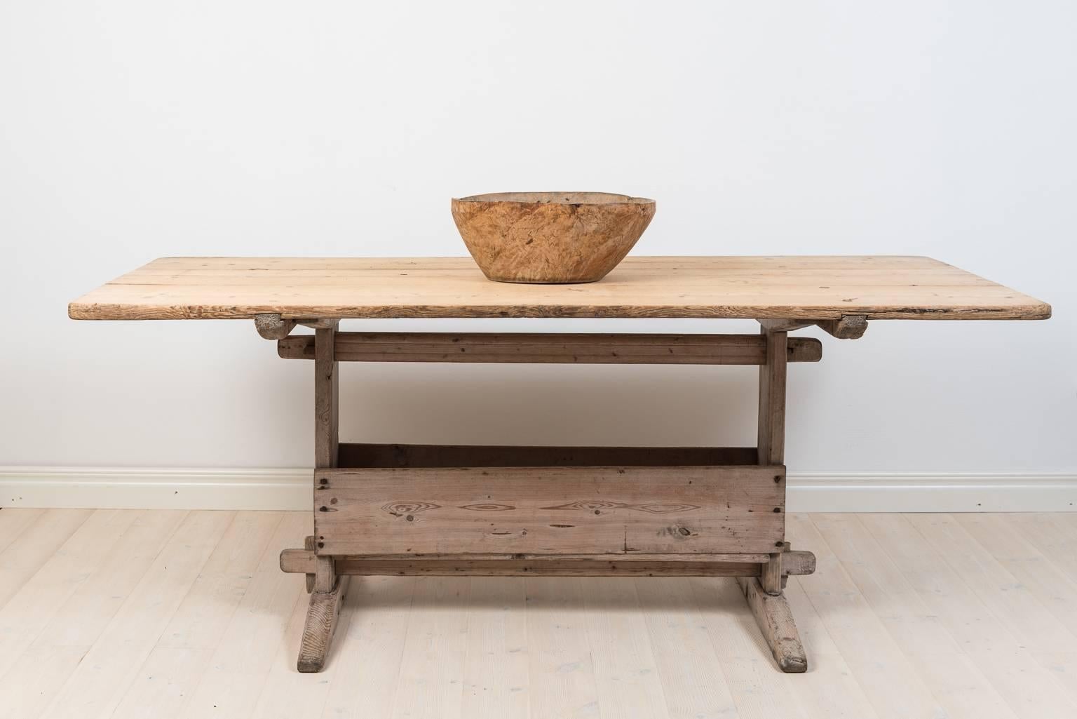 18th century Swedish  folk art table with rectangular removable table top on a leg frame of trestles. The table has never been painted and has a natural worn surface due to 250 years of use. The table is from a small village just east of Sweden’s