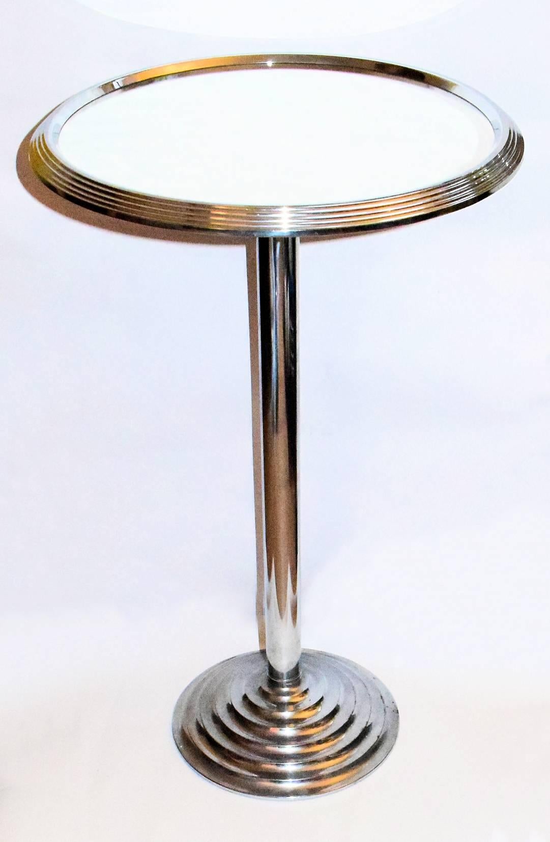 Dating to the 1930s is this fabulously glamourous mirror top table. Originating from France this table is in great condition. The top and base have stepped chrome edges and the stem is chrome. The underside of the top is wood and the underside of