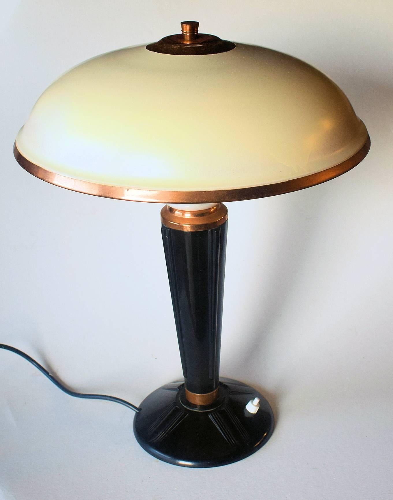 Designed by Eileen Gray for the French Jumo company and dating to the 1930s-1940s this very stylish lamp is made from two primary components which are bakelite and metal. Superb mushroom shape enameled metal shade with copper accents and finial.