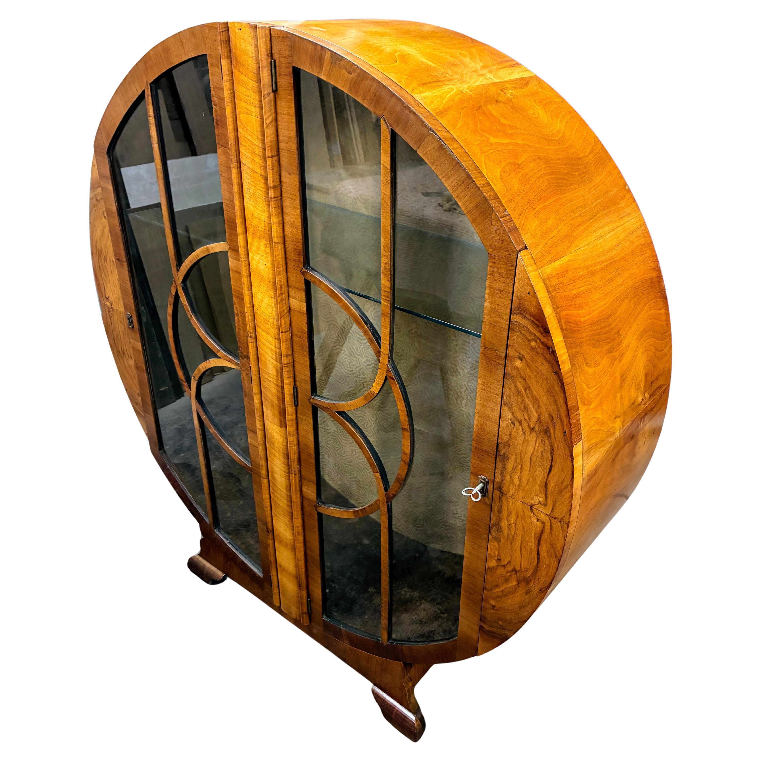 Fabulous, original 1930s Art Deco display cabinet. This lovely figured walnut veneered mid-tone cabinet features a generously sized interior display area for your 'collections'. Beautiful Deco astragal to the glass to the doors. The doors work very
