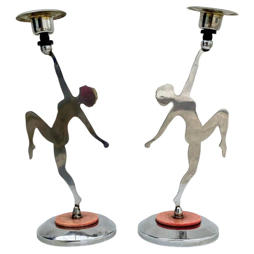 For your consideration are these attractive matching pair of chrome & bakelite candlesticks. Each candlestick depicts a two dimensional silhouette of a nude female in a dancing pose. Made in England these were relatively common. They have become