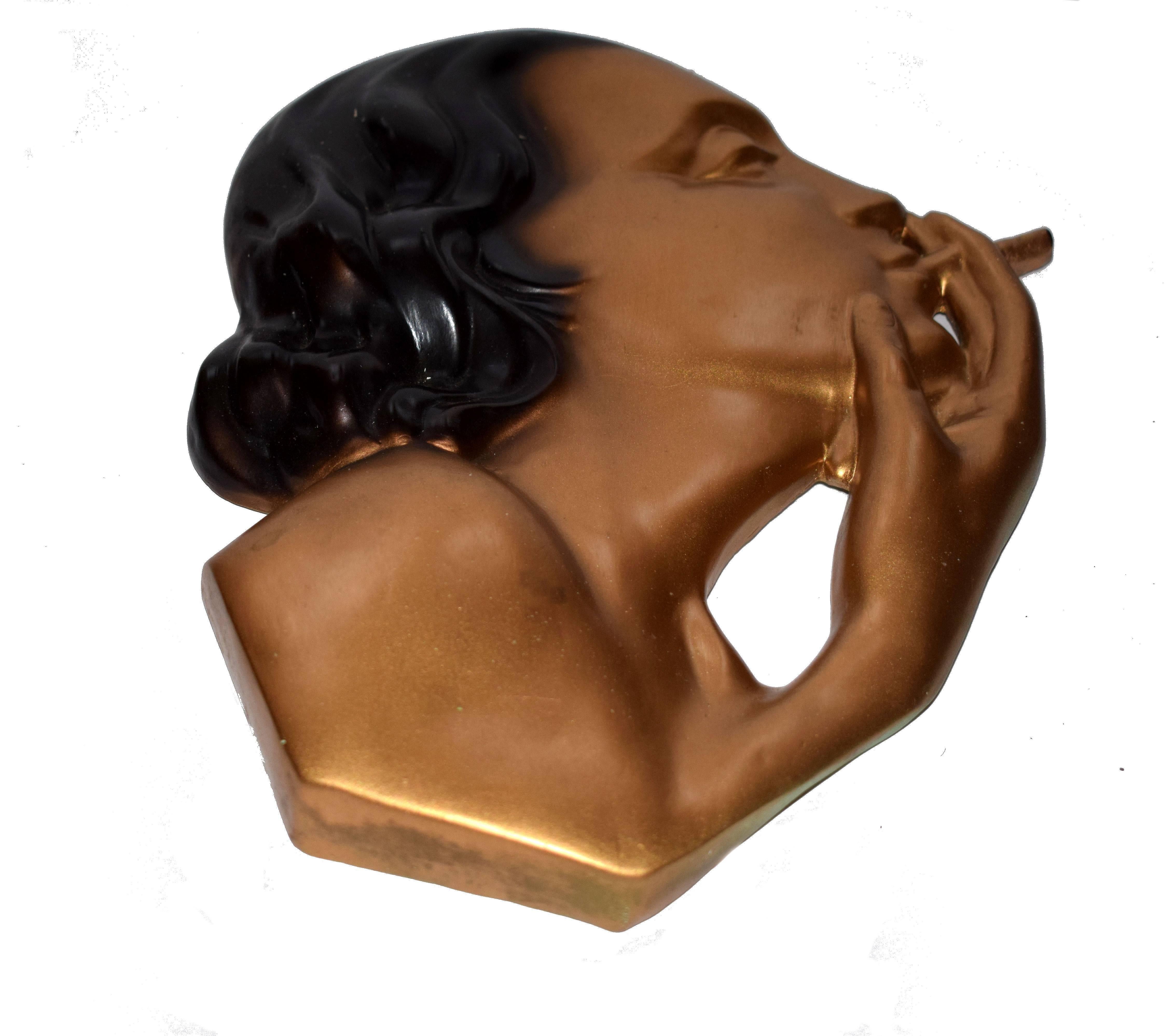 This is a wonderful 1930s Art Deco wall mask, totally authentic and very unusual, not one we've seen before. Depicting the profile of a 1920s lady smoking. She's made from gilded plaster and has a hook to the reverse to hand by. She's an impressive