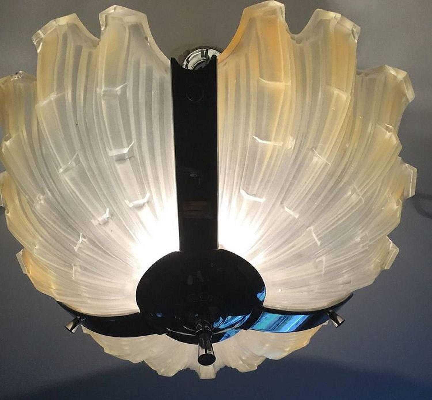 A large and heavy Art Deco ceiling light in lovely original condition. The chrome frame housing three large and very heavy opaque petal type shades, these are held in place by chrome brackets which secure each petal individually and make them slot